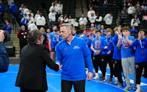Simley coach Will Short, his team behind him, accepted his medal after the program's sixth state championship in a row.