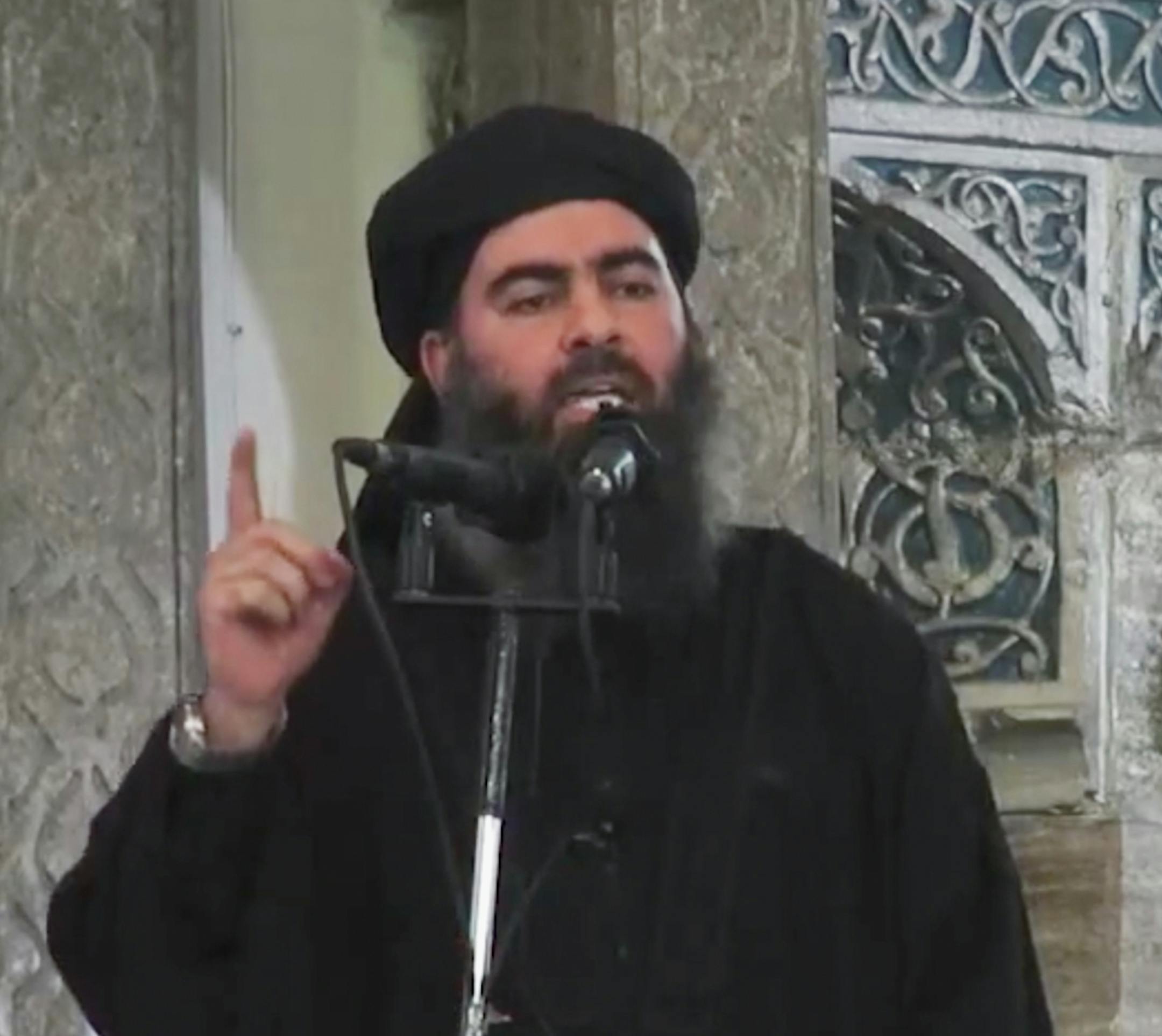 This image made from video posted on a militant website Saturday, July 5, 2014, which has been authenticated based on its contents and other AP reporting, purports to show the leader of the Islamic State group, Abu Bakr al-Baghdadi, delivering a sermon at a mosque in Iraq. A video posted online Saturday purports to show the leader of the Islamic State extremist group that has overrun much of Syria and Iraq delivering a sermon at a mosque in Iraq, in what would be a rare - if not the first - publ