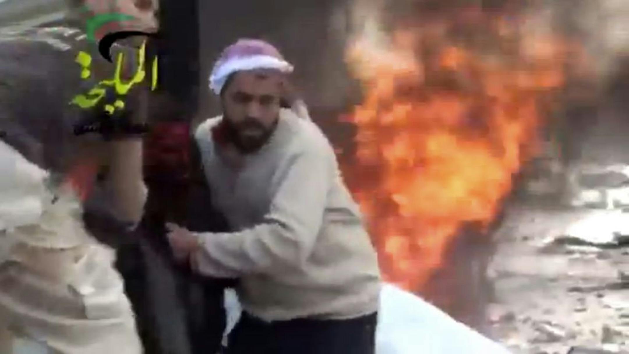 This image, taken from video, shows a rescue after a jet attacked a fuel station in the Damascus area.