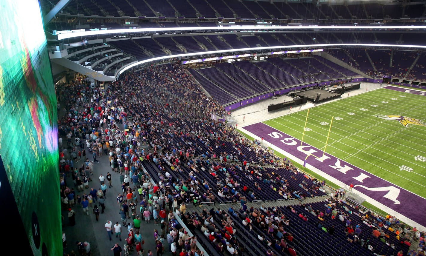 A large crowd was on hand for the public opening at the U.S. Bank Stadium as the current radar of a fast moving storm was visible (on video screen at left) Saturday, July 23, 2016, in Minneapolis, MN.