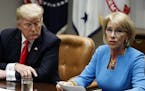 President Donald Trump listens as Secretary of Education Betsy DeVos speaks during a roundtable discussion on the Federal Commission on School Safety 