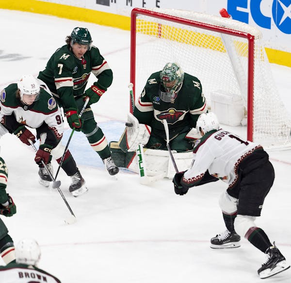 Wild goaltender Marc-Andre Fleury stops a shot by Coyotes right winger Dylan Guenther, right, Tuesday night at Xcel Energy Center.