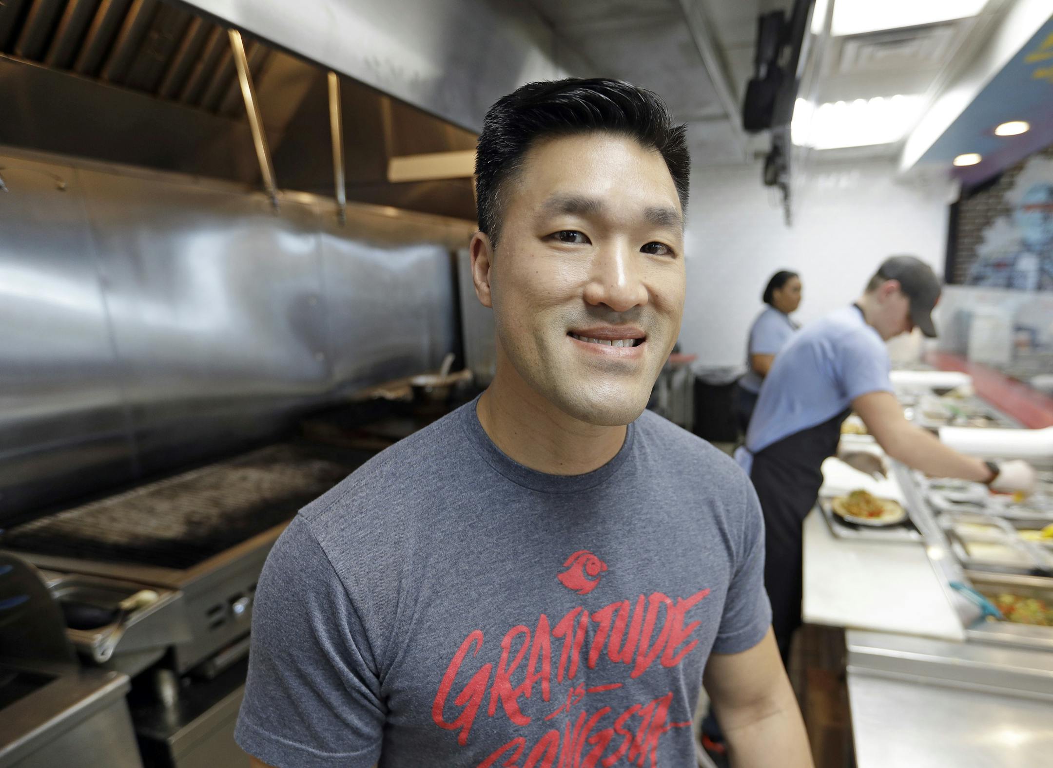 In this Tuesday, April 10, 2018, photo, Thomas Nguyen poses inside his Peli Peli Kitchen restaurant in Houston. Owner Thomas Nguyen had a change of heart after transitioning one of his three Peli Peli South African fine dining restaurants and his Peli Peli Kitchen fast casual location to a no-cash policy. (AP Photo/David J. Phillip) ORG XMIT: TXDP101