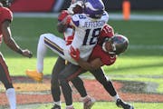 Tampa Bay strong safety Antoine Winfield Jr. (31) takes down Vikings wide receiver Justin Jefferson after a catch during the second half