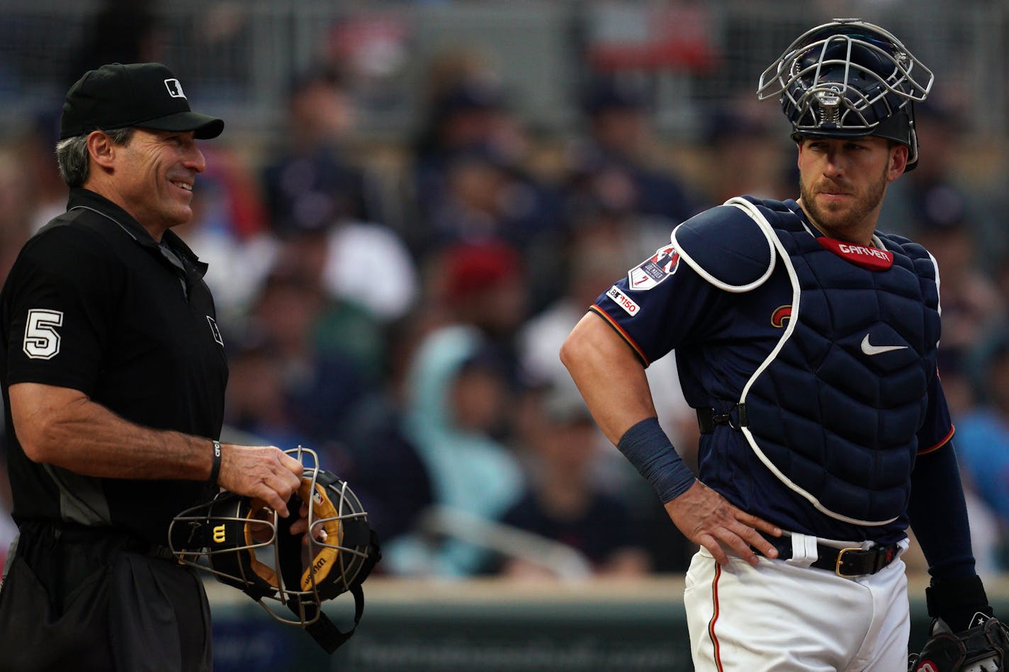 Twins catcher Mitch Garver stood with umpire Angel Hernandez behind home plate last June.