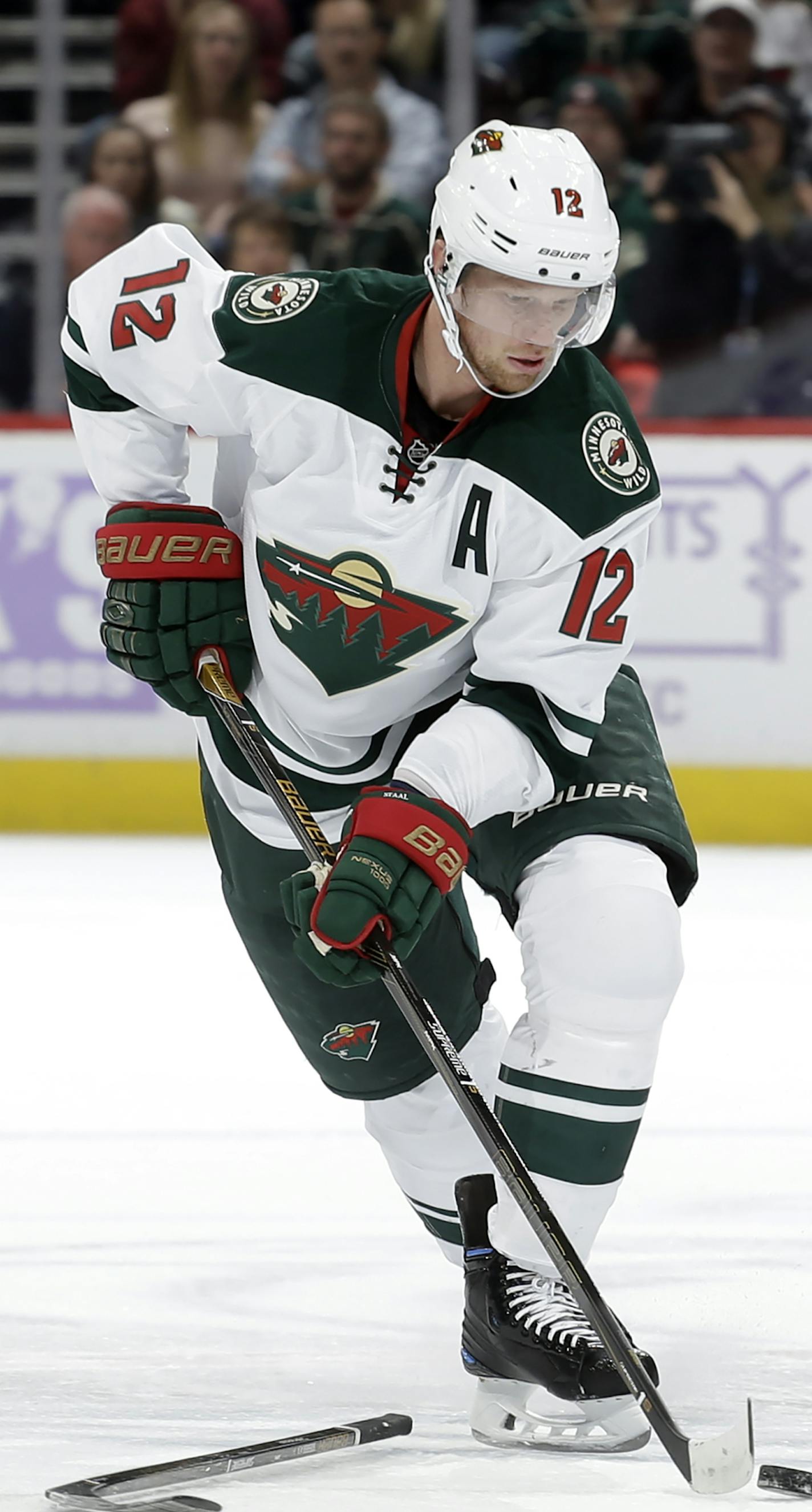 Minnesota Wild center Eric Staal (12) moves the puck down the ice against the Colorado Avalanche during the first period of an NHL hockey game, Saturday, Nov. 5, 2016, in Denver. (AP Photo/Jack Dempsey)