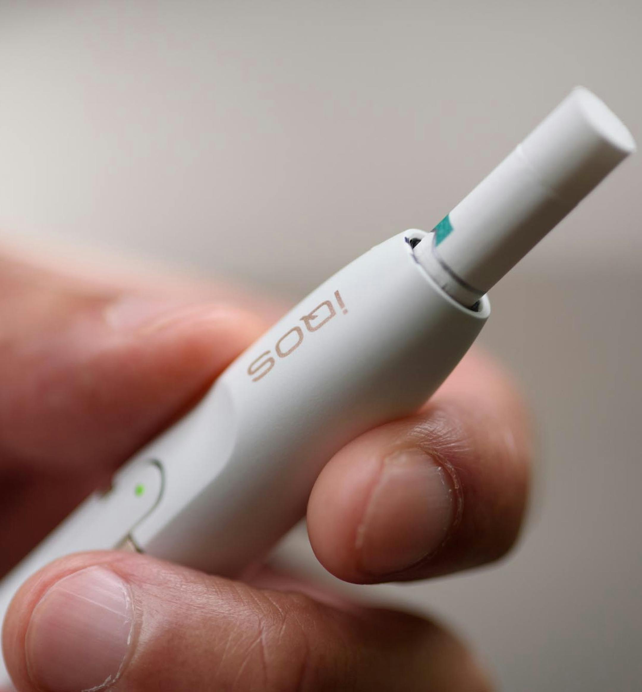A Philip Morris International iQOS electronic cigarette is held for a photograph in Tokyo on Aug.23, 2016. MUST CREDIT: Bloomberg photo by Akio Kon.