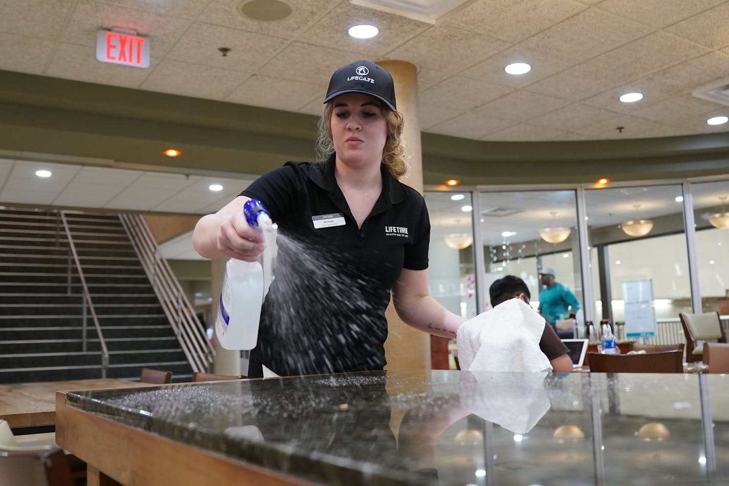 Michelle Quade cleaned surfaces in the Life Time Cafe at Life Time Fitness with Purell surface disinfectant more frequently on surfaces around the club. ] GLEN STUBBE &#x2022; glen.stubbe@startribune.com Wednesday, March 11, 2020 Workers at Life Time Fitness used Purell surface disinfectant more frequently on surfaces around the club.