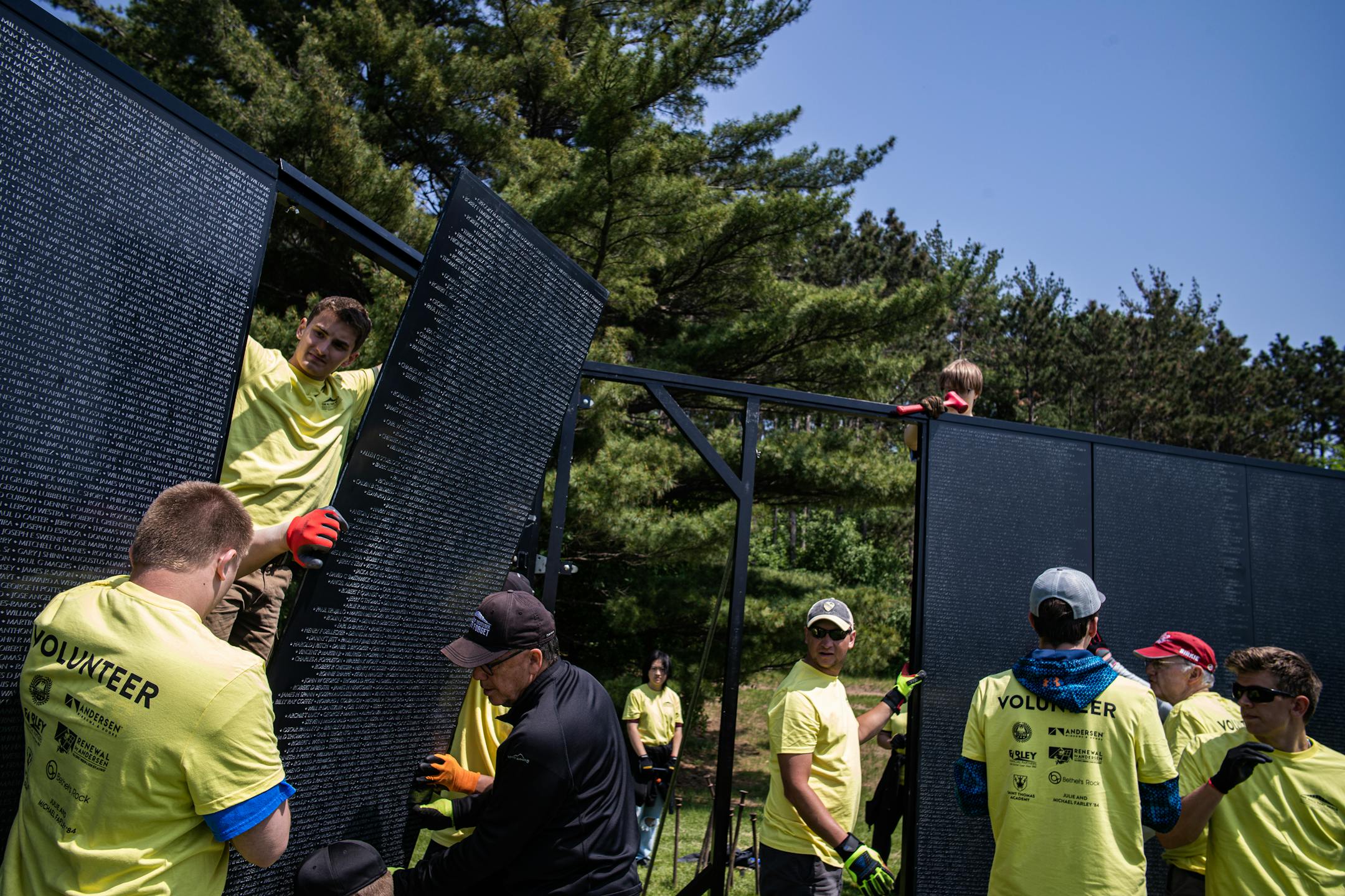 St. Thomas Academy cadets and volunteers help assemble a 3/4 scale of the Wall That Heals that contains 58,281 names of Vietnam Veterans who died in combat.