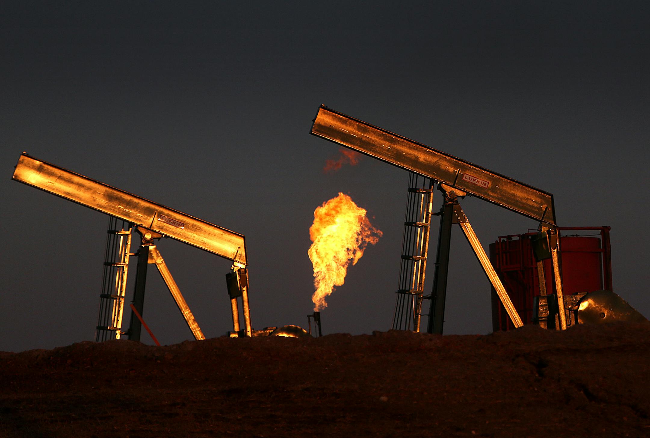 Excess natural gas is burned off at well sites, as seen at a well east of Williston, ND, in the heart of the Bakken oil region. It is hoped that the installation of pipelines will ultimately allow the gas to be contained and utilized. ] (JIM GEHRZ/STAR TRIBUNE) / May 2, 2013 / 12:00 PM Williston, ND and region √ê BACKGROUND INFORMATIN-According to the latest U. S. Geological Survey estimate, there are 7.4 billion barrels of recoverable oil in Western North Dakota and Montana, more th