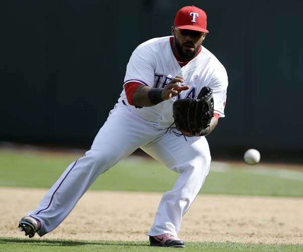 Texas Rangers first baseman Prince Fielder fields a ground ball from the Boston Red Sox in a baseball game, Sunday, May 11, 2014, in Arlington, Texas.
