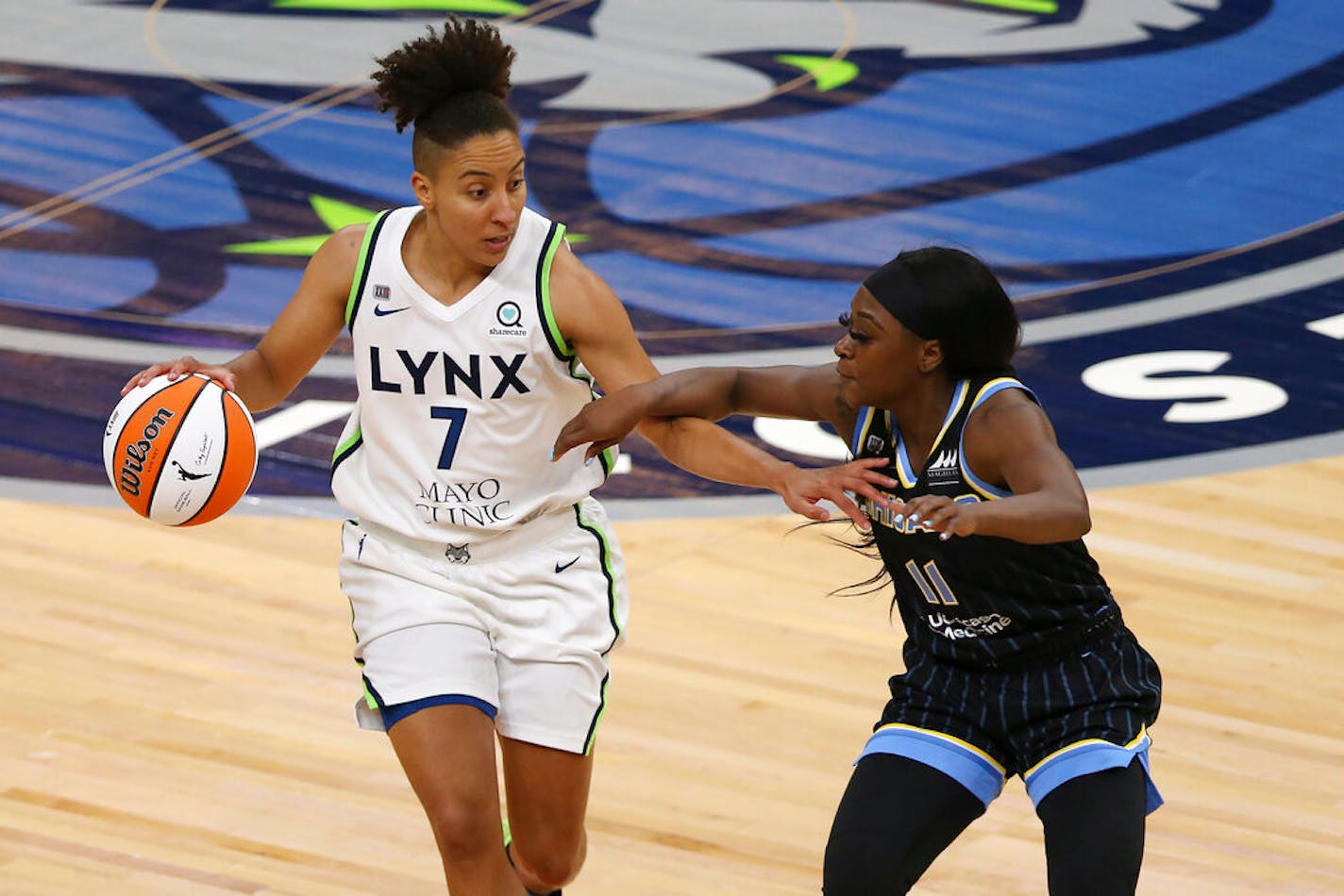 Minnesota Lynx's Layshia Clarendon (7) is defended by Chicago Sky's Dana Evans (11) during the second half of a WNBA basketball game Tuesday, June 15, 2021, in Minneapolis. Chicago won 105-89. (AP Photo/Stacy Bengs)