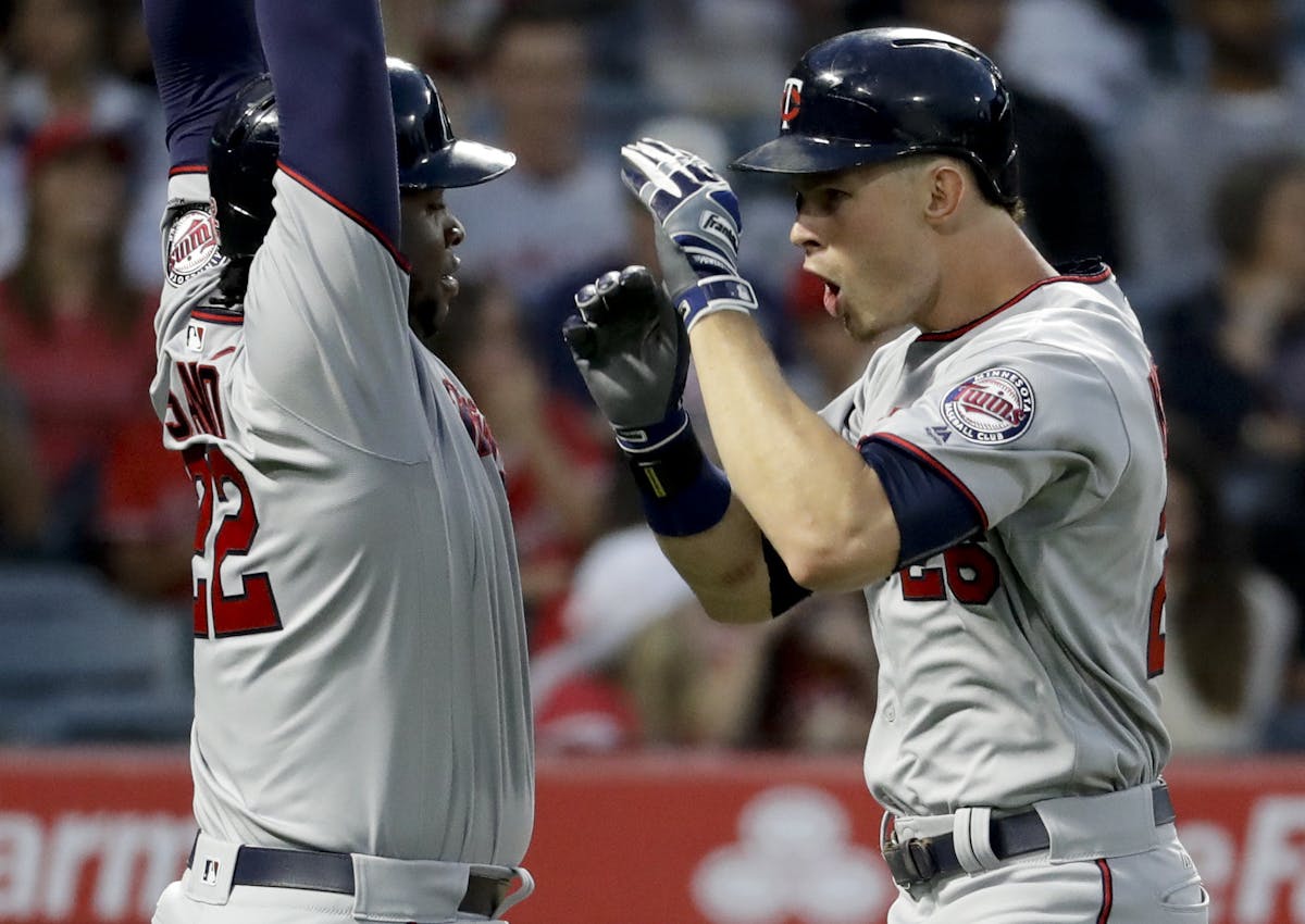 Minnesota Twins' Max Kepler, right, celebrates his two-run home run with Miguel Sano during the third inning of the team's baseball game against the L