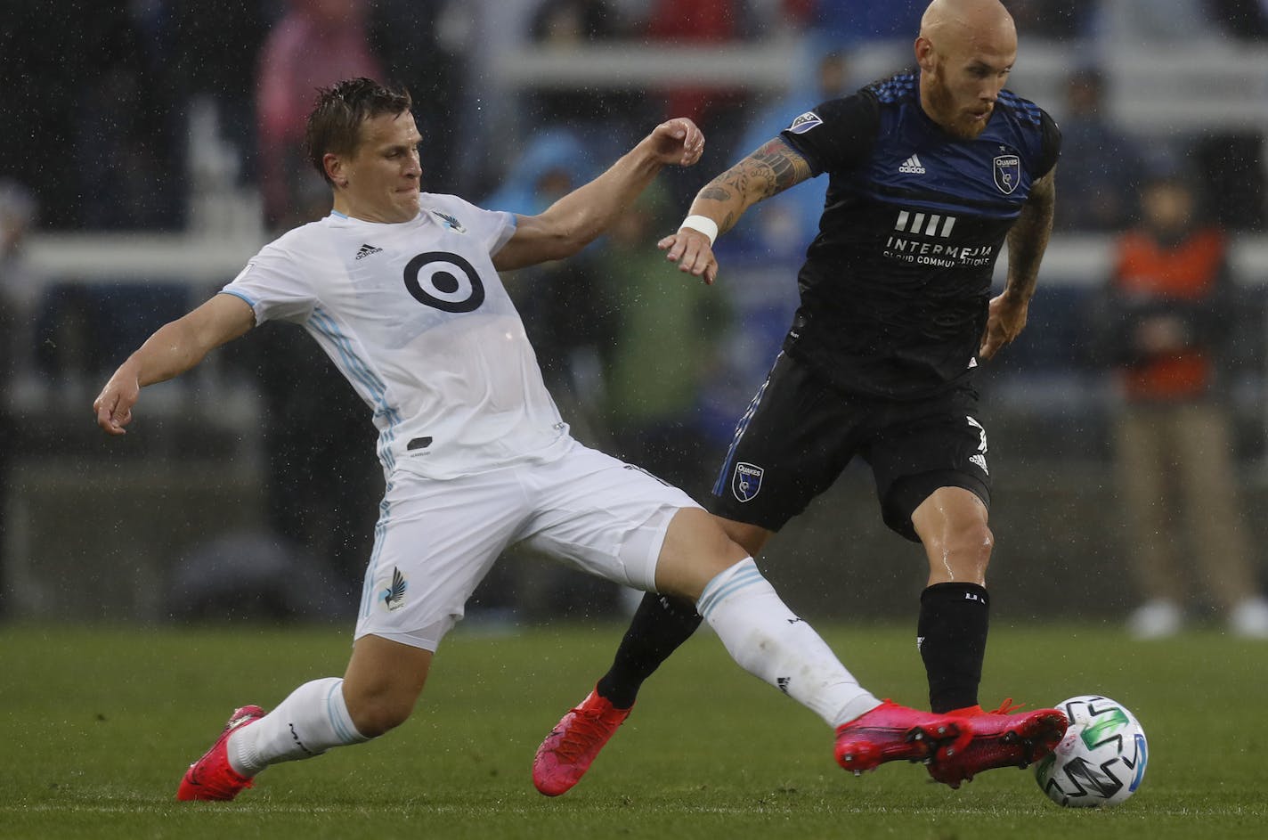 San Jose Earthquakes' Magnus Eriksson (7) keeps the ball away from Minnesota United FC's Robin Lod, left, in the first half of an MLS soccer match in San Jose, Calif., Saturday, March 7, 2020. (Nhat V. Meyer/Bay Area News Group via AP)