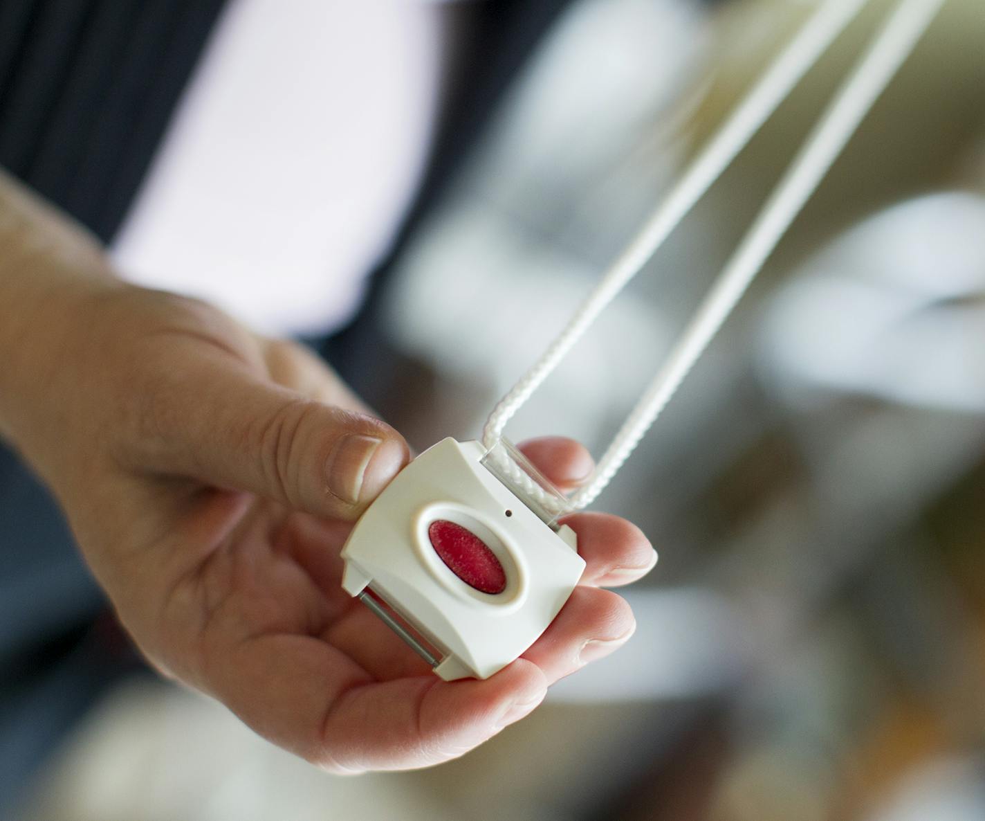 The Healthsense eNeighbor system offers emergency buttons, such as this one that can be worn around the neck, as well as motion detectors in living spaces. Photographed at the Evans residence in St. Paul December 15, 2015. (Courtney Perry/Special to the Star Tribune)