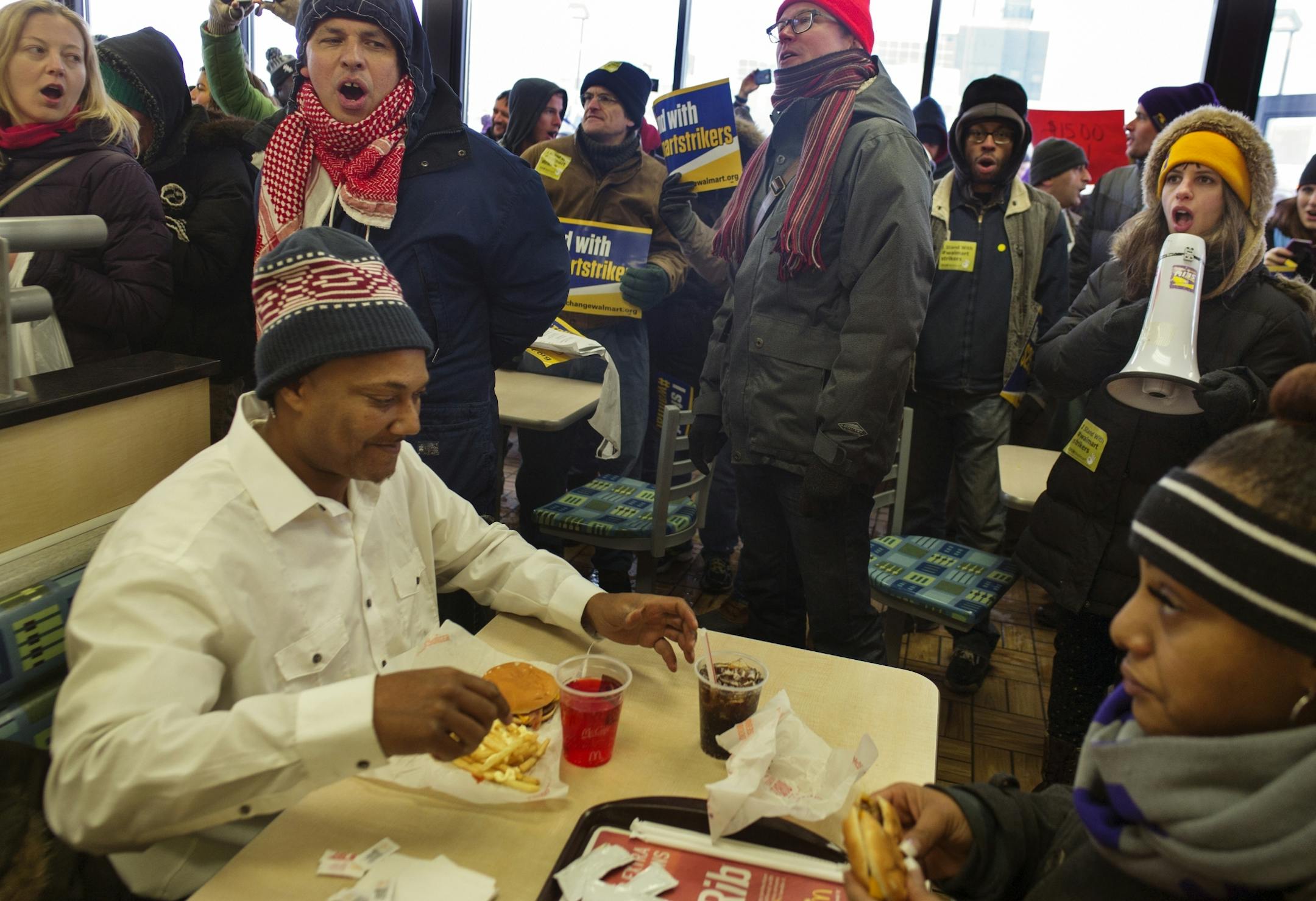 Near the Walmart near the intersection of Snelling and University in St. Paul, protesters entered a McDonald to demand living wages from the corporation. Diners Jerry Harrell and Jelahn Carter were sympathetic. Carter makes minimum wage working full time and supporting two kids as a single parent.