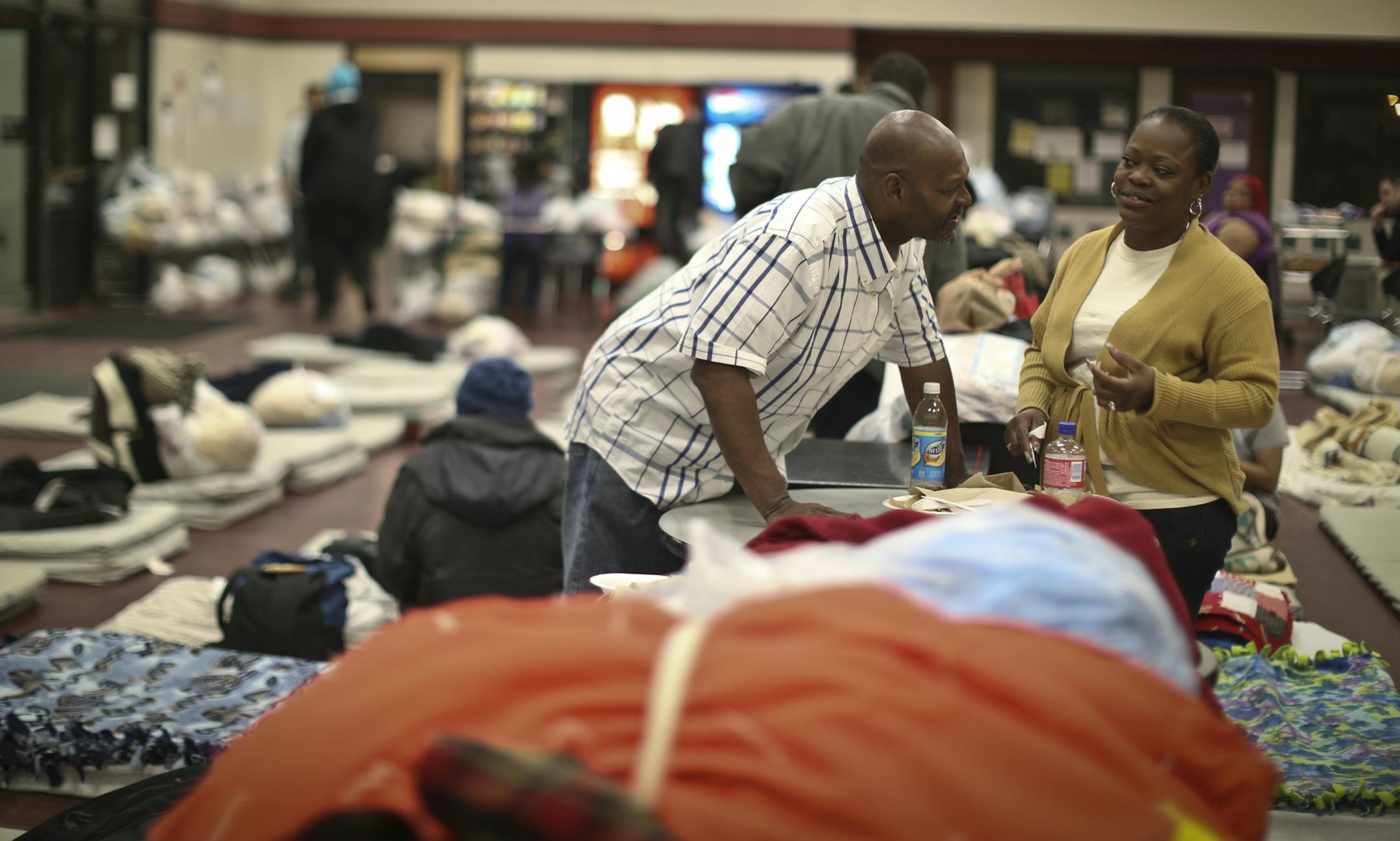 George Smith chatted with his wife Ristina Johnson as they ate dinner while people crowded into the Dorothy Day Center in St. Paul, Minn. on Thursday evening, May 2, 2013. Smith and his wife lost their housing a month ago after health problems and are staying at the center temporarily. They sleep as close as they can together, on the border of tables and chairs that separates the men and women in one of the rooms at the center. ] (RENEE JONES SCHNEIDER * reneejones@startribune.com) Ristina CQ