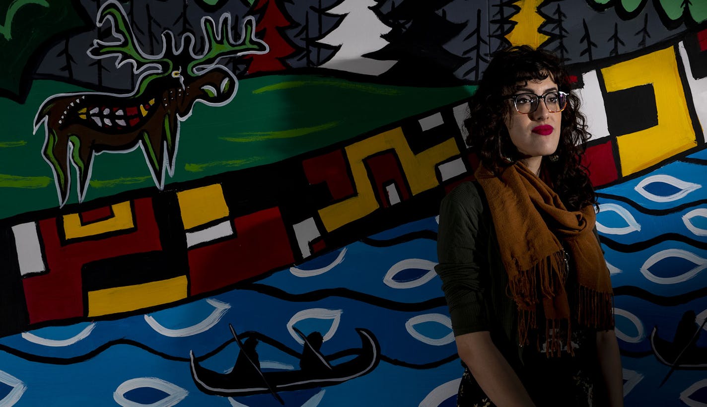 Moira Villiard, a local artist, posed for a portrait in front of her mural in the Kirby Student Center at the University of Minnesota Duluth on Thursday February 27, 2020. The mural is of the Ojibwe people migrating to the region while following the prophecy of looking for "where the food grows on water". It is a visual representation of a land acknowledgment of the indigenous people that settled on this land before any European immigrants arrived. ]
ALEX KORMANN &#x2022; alex.kormann@startribun