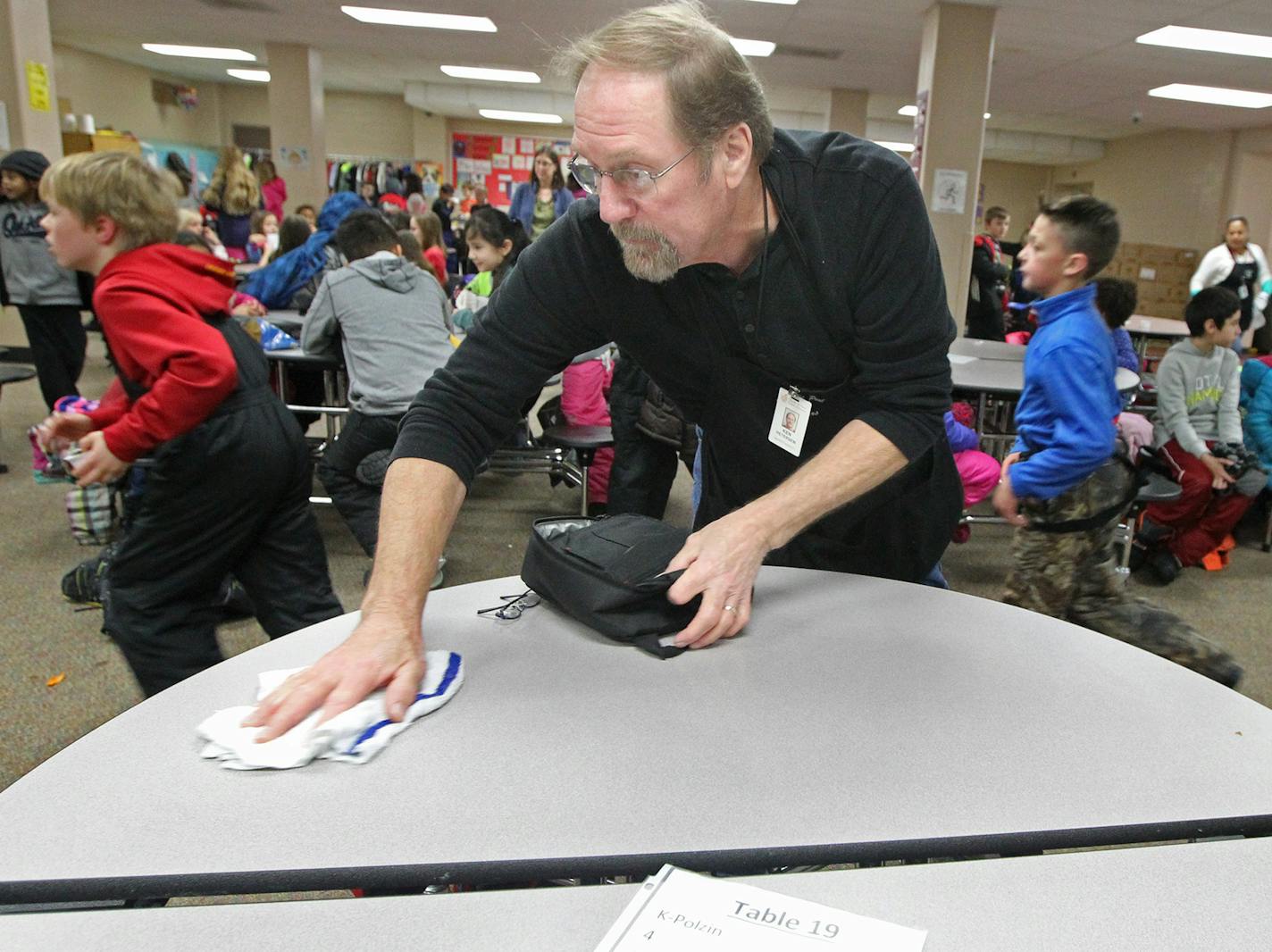 Former Teamster Ken Petersen cleaned off tables during the lunch hour at Lincoln Center Elementary in South St. Paul, where he went to work after retirement. He is one of many people facing cuts to their pensions.