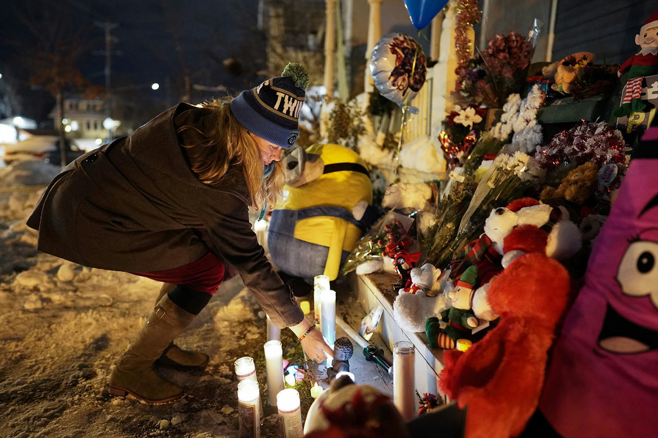 Christine Lorenz tended to candles lit at the vigil. Lorenz previously worked with Kjersten Schladetzky.