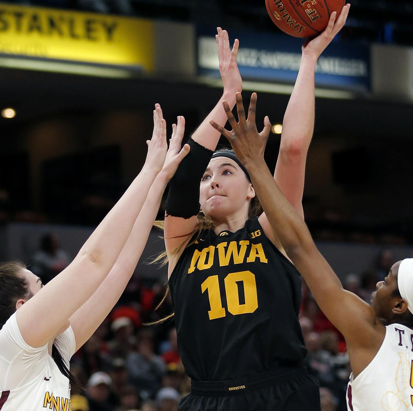 INDIANAPOLIS, IN - MARCH 02: Iowa Hawkeyes forward Megan Gustafson (10) fires up the jump shot from the lane over Minnesota Golden Gophers center Bryanna Fernstrom (14) and Minnesota Golden Gophers forward Taiye Bello (5)during the game between the Iowa Hawkeyes and Minnesota Golden Gophers on March 2, 2018, at Bankers Life Fieldhouse in Indianapolis, IN (Photo by Jeffrey Brown/Icon Sportswire) (Icon Sportswire via AP Images) ORG XMIT: 306050