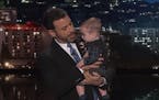 Jimmy Kimmel held his baby son as he returned to his late-night show after a week off for the boy's heart surgery.