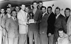 Sid and the champs: The 1950 NBA champion Minneapolis Lakers featured Sid Hartman, far left; star players Jim Pollard and George Mikan, both holding t