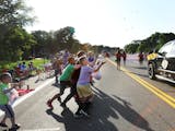 People along the parade route for Champlin’s annual Father Hennepin Festival competed for tossed candy in June 2019. The Father Hennepin Festival is