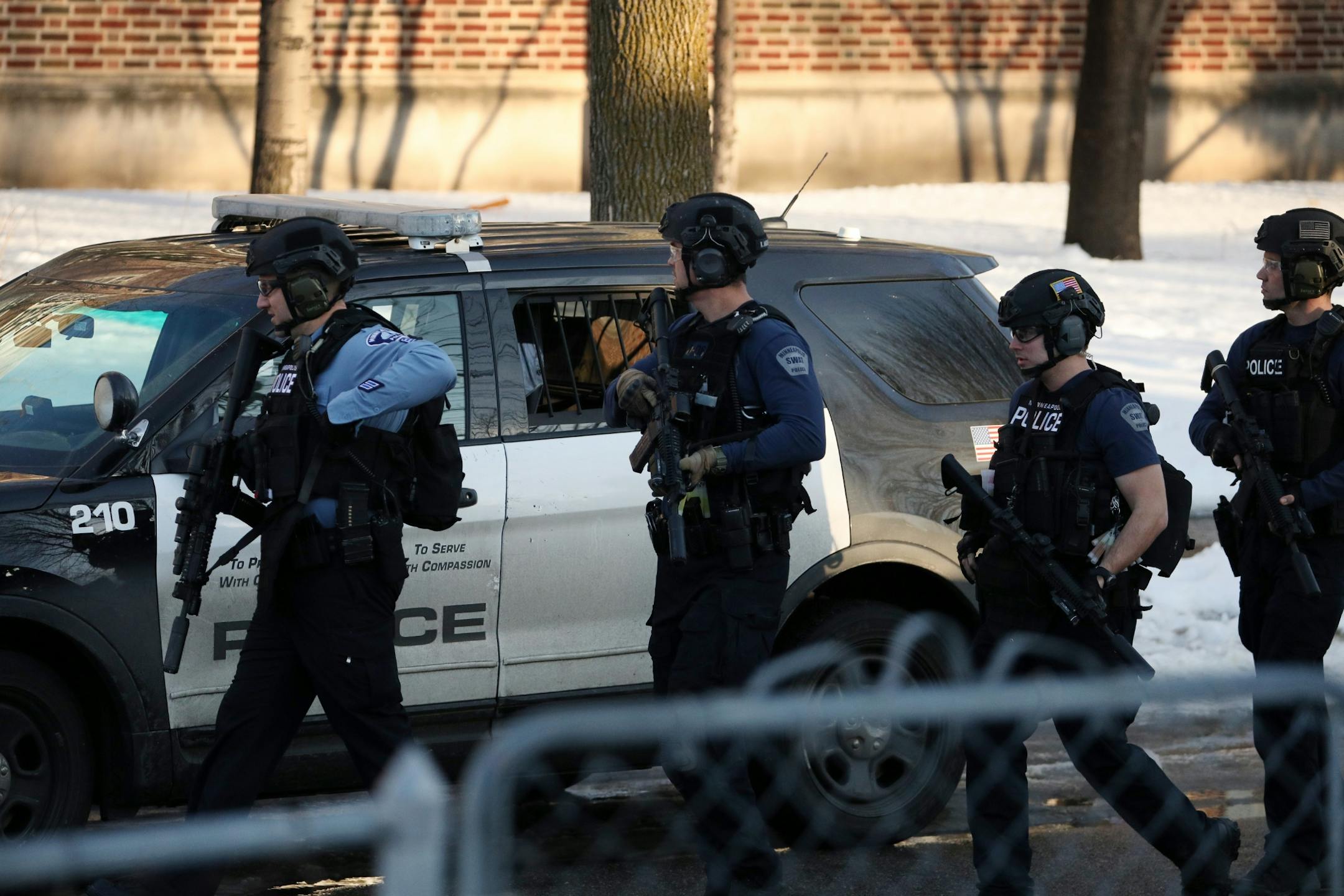 Police in tactical gear entered Patrick Henry High School after a gunman was reported getting off a Metro Transit bus near the school Tuesday.