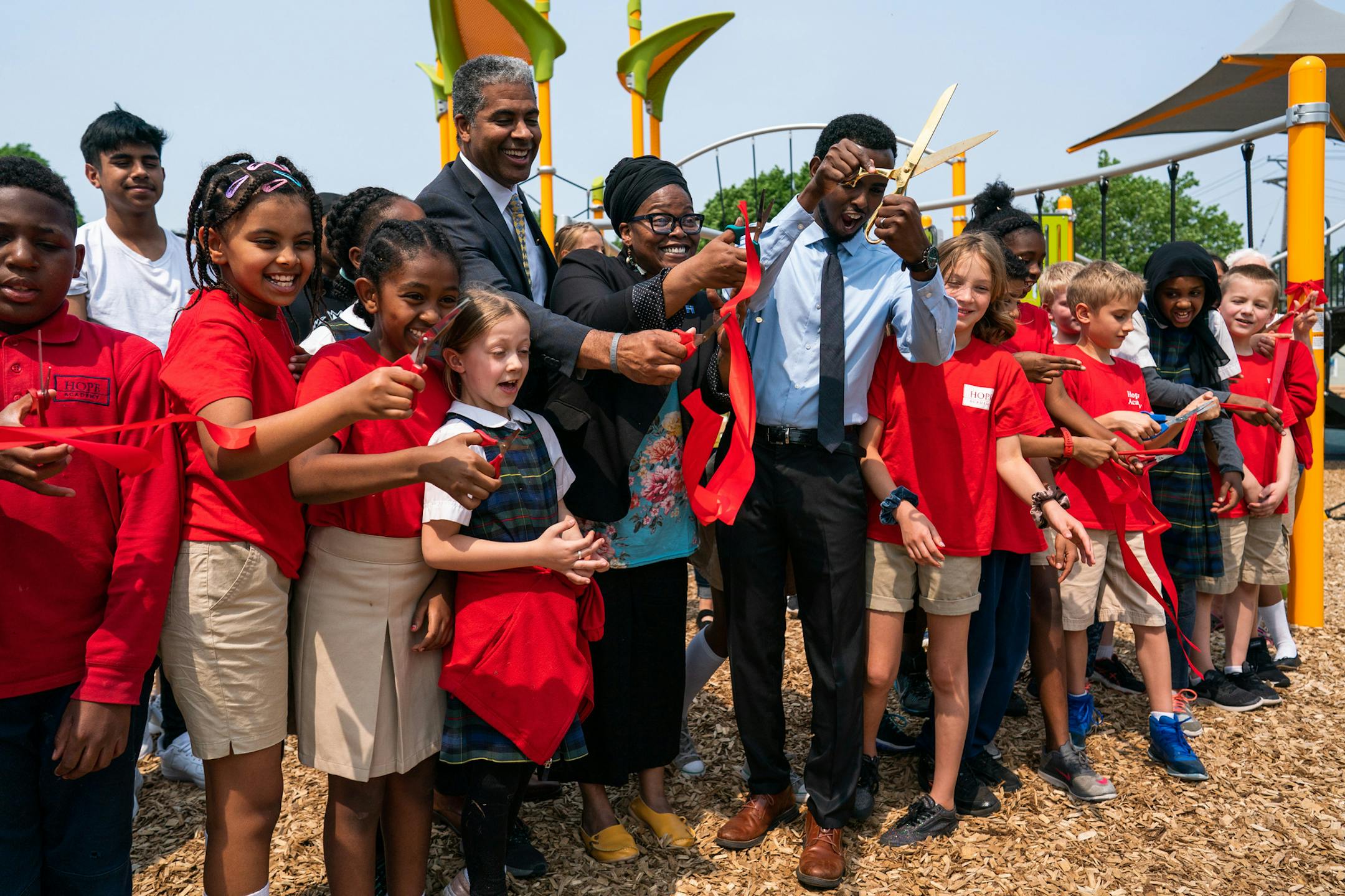 Hennepin county commissioner Angela Conley (center), flanked by Minneapolis Park and Recreation Board superintendent Al Bangoura (left) and commissioner AK Hassan cut a ceremonial ribbon to open the park. ] MARK VANCLEAVE ¥ Park and neighborhood leaders celebrated the renovated Peavey Park at Franklin and Chicago avenues in south Minneapolis on Friday, May 31, 2019.