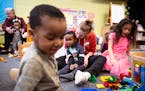 Playschool Child Care teacher Emily Lawson, center, plays with toddlers and preschoolers in her care Tuesday, April 4, 2023 in Maplewood, Minn. AARON 