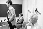 Minnesota Vikings coach Bud Grant, right, seems to have other things on his mind than new Coach Les Steckel's remarks to a press conference at the tea