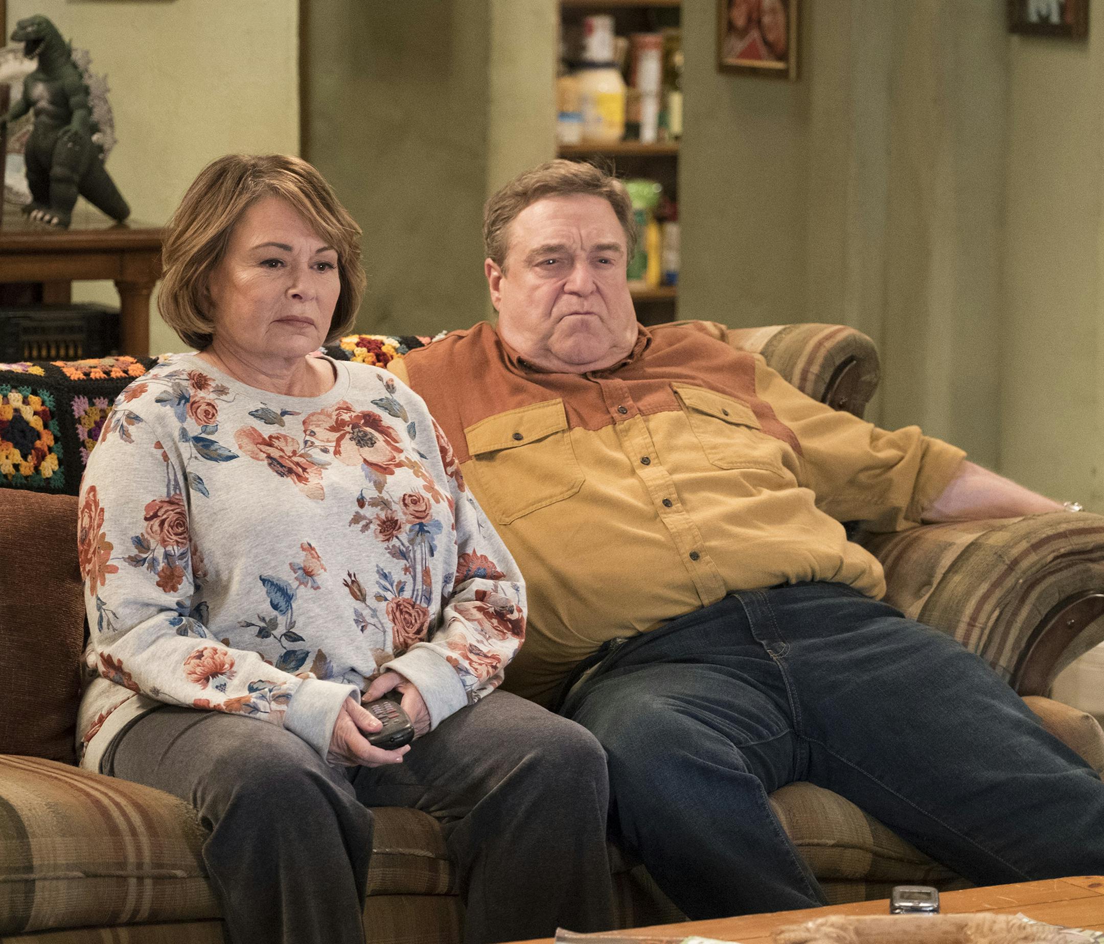 In this image released by ABC, Roseanne Barr, left, and John Goodman appear in a scene from the reboot of "Roseanne," premiering on Tuesday at 8 p.m. EST. (Adam Rose/ABC via AP)