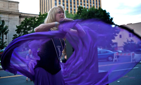 Billie LaTease Austin, who is running for Empress of the Imperial Court of Minnesota, danced at the opening of the GLBT Pride Week celebration.