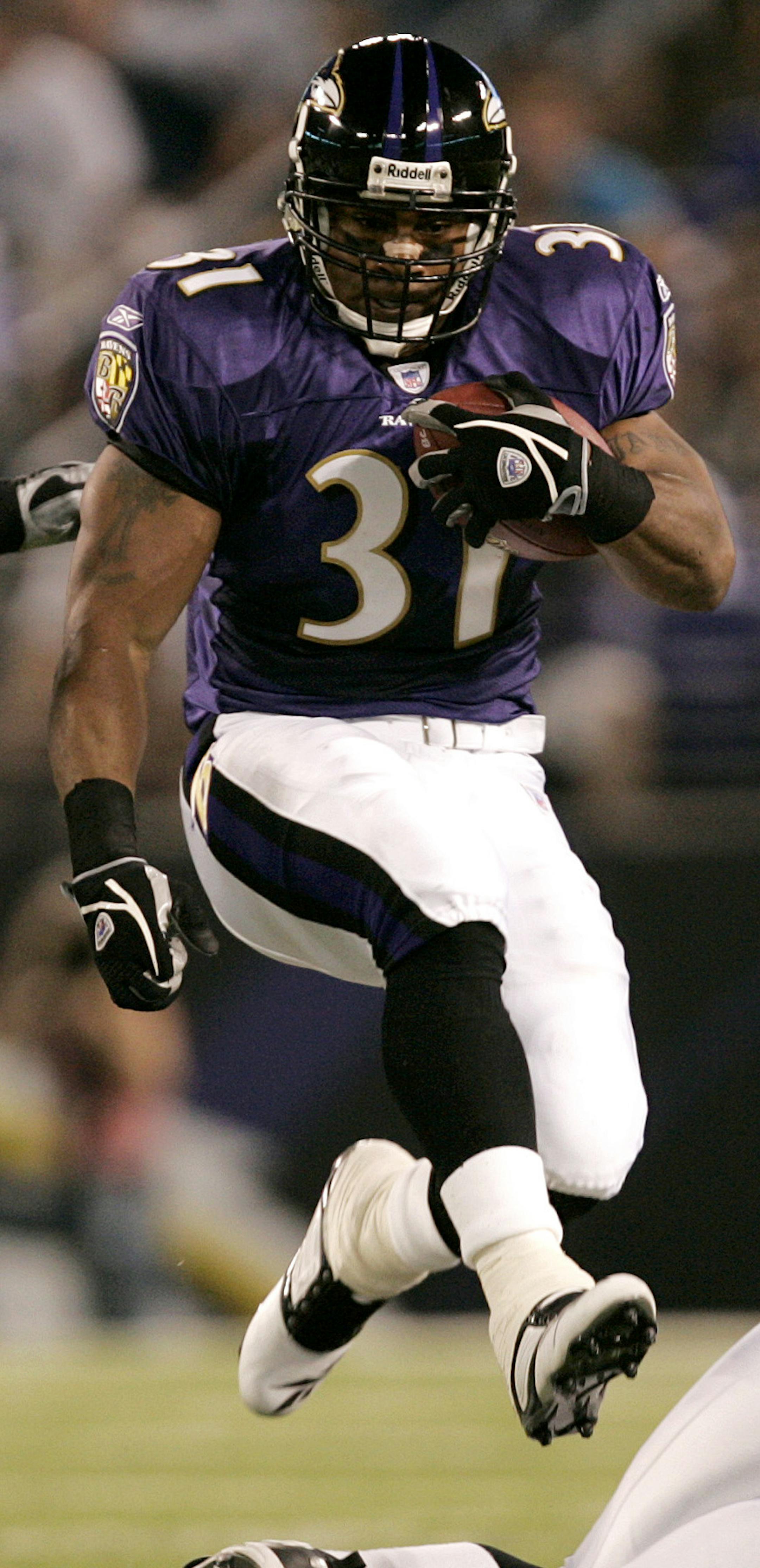 Baltimore Ravens running back Jamal Lewis, center, hops over teammate Adam Terry, right, as he is chased by Philadelphia Eagles Matt McCoy, left, and Dhani Jones, second from left, during the first quarter of their pre-season football game in Baltimore, Thursday, Aug. 17, 2006.(AP Photo/Chris Gardner) ORG XMIT: BAF101