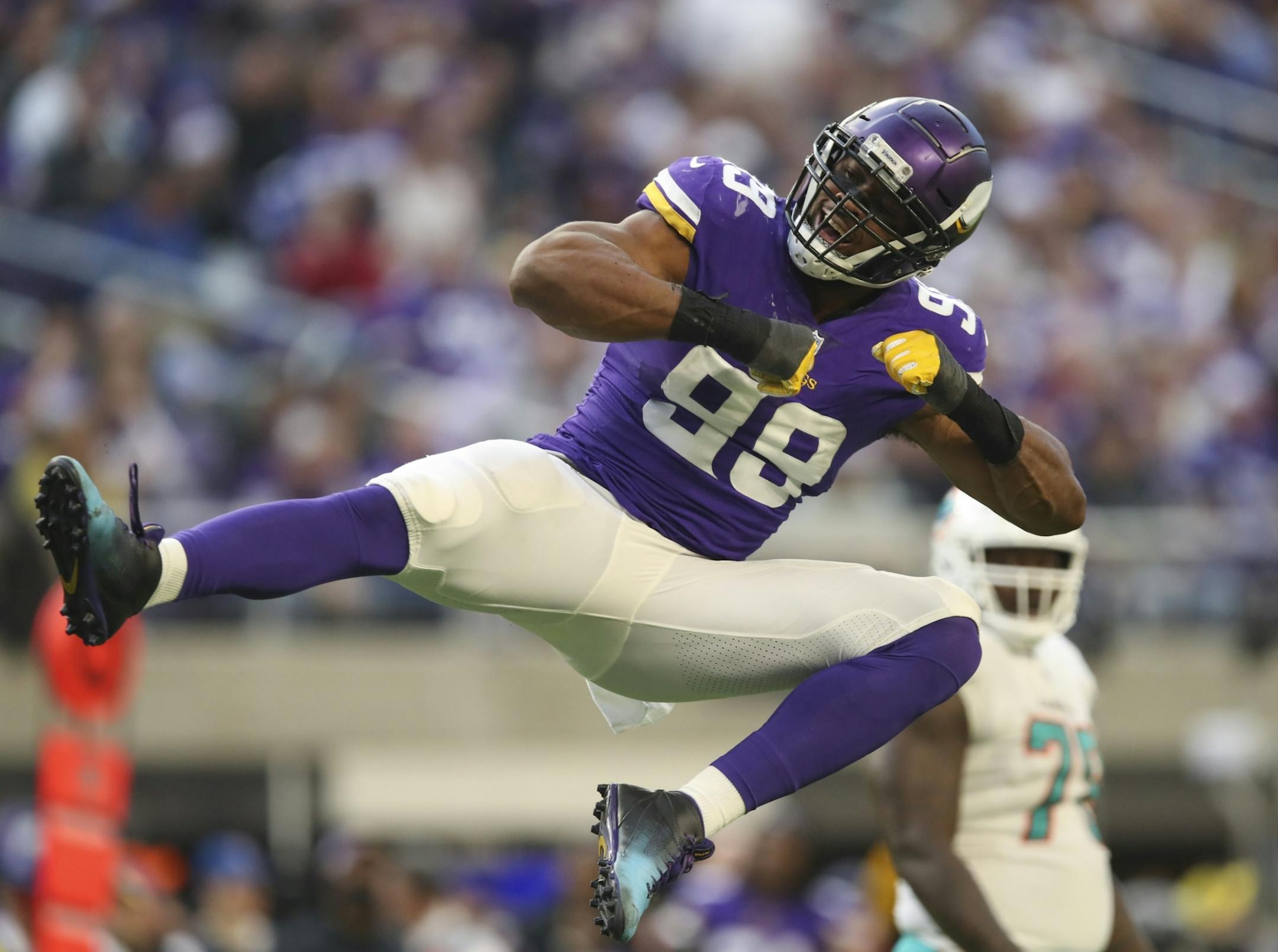 Minnesota Vikings defensive end Danielle Hunter (99) celebrated after he sacked Miami Dolphins quarterback Ryan Tannehill for a nine yard loss in the third quarter.