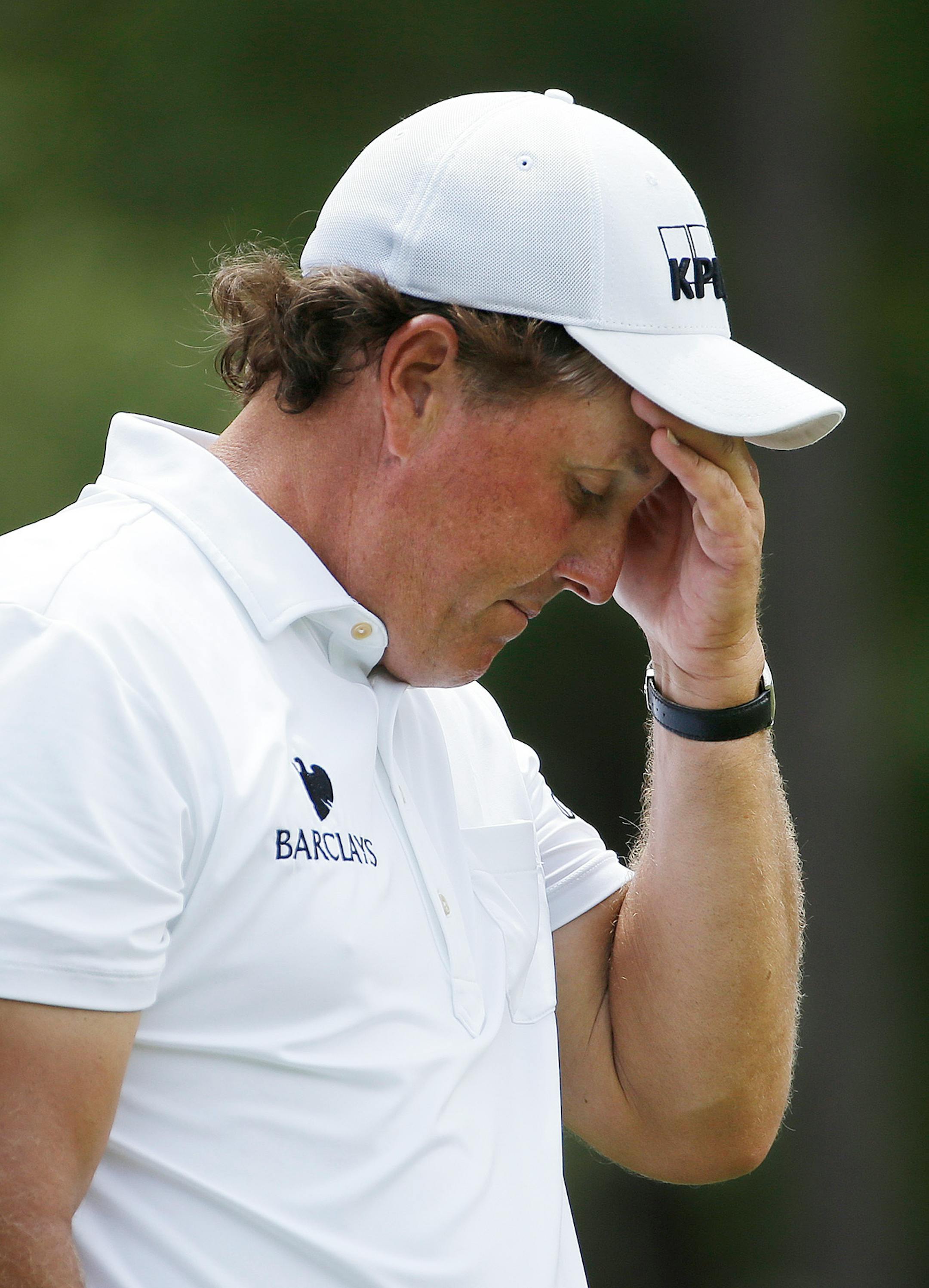 Phil Mickelson reacts to his tee shot on the ninth hole during the third round of the U.S. Open golf tournament in Pinehurst, N.C., Saturday, June 14, 2014.