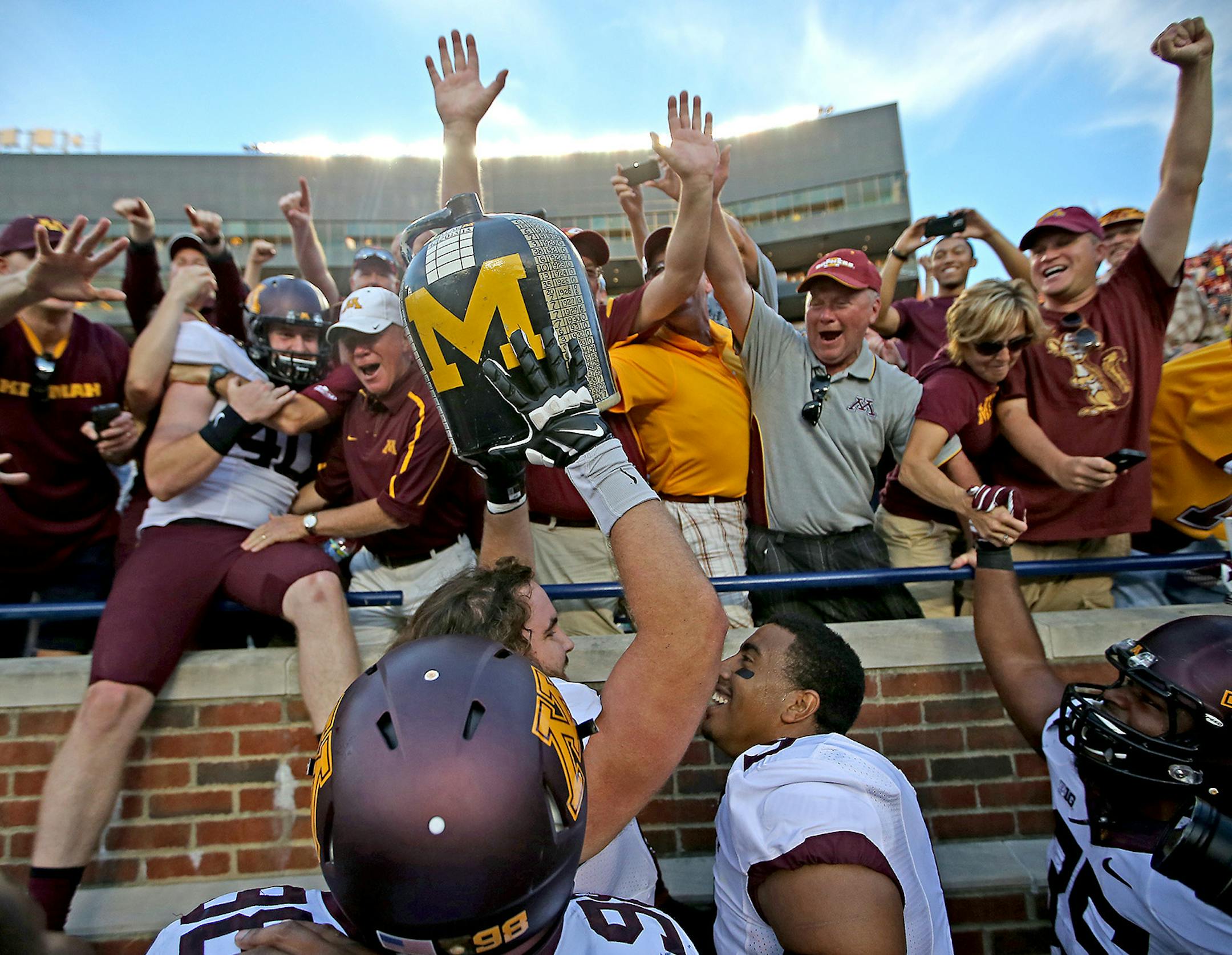 Minnesota Gopher players and fans celebrated with the Little Brown Jug after defeating Michigan 30-14 at Michigan Stadium, Saturday, September 27, 2014 in Ann Arbor, MI. ] (ELIZABETH FLORES/STAR TRIBUNE) ELIZABETH FLORES • eflores@startribune.com