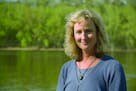 Deborah Swackhamer, former director of the University of Minnesota Water Resources Center, poses along the Mississippi River.