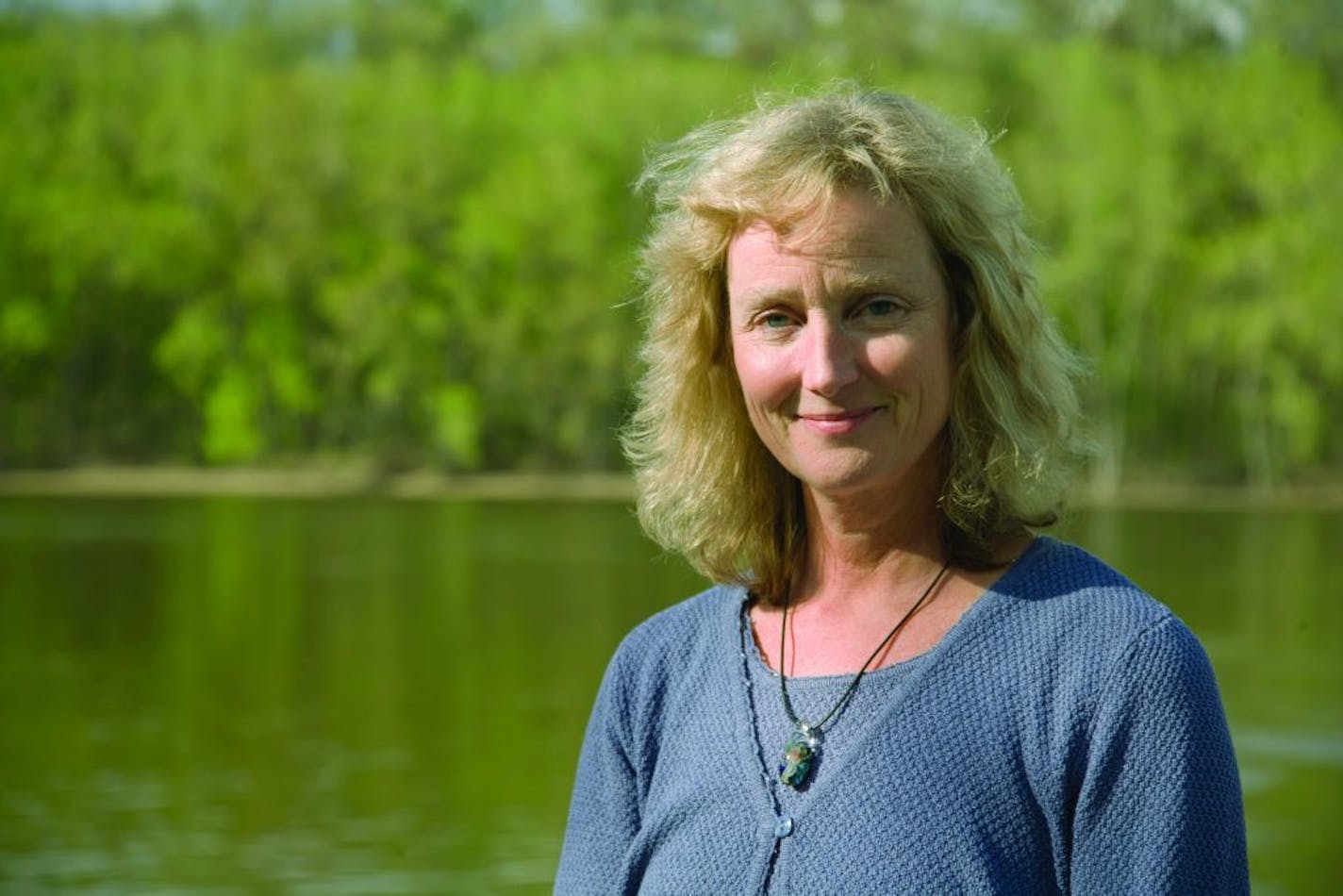 Deborah Swackhamer, former director of the University of Minnesota Water Resources Center, poses along the Mississippi River.