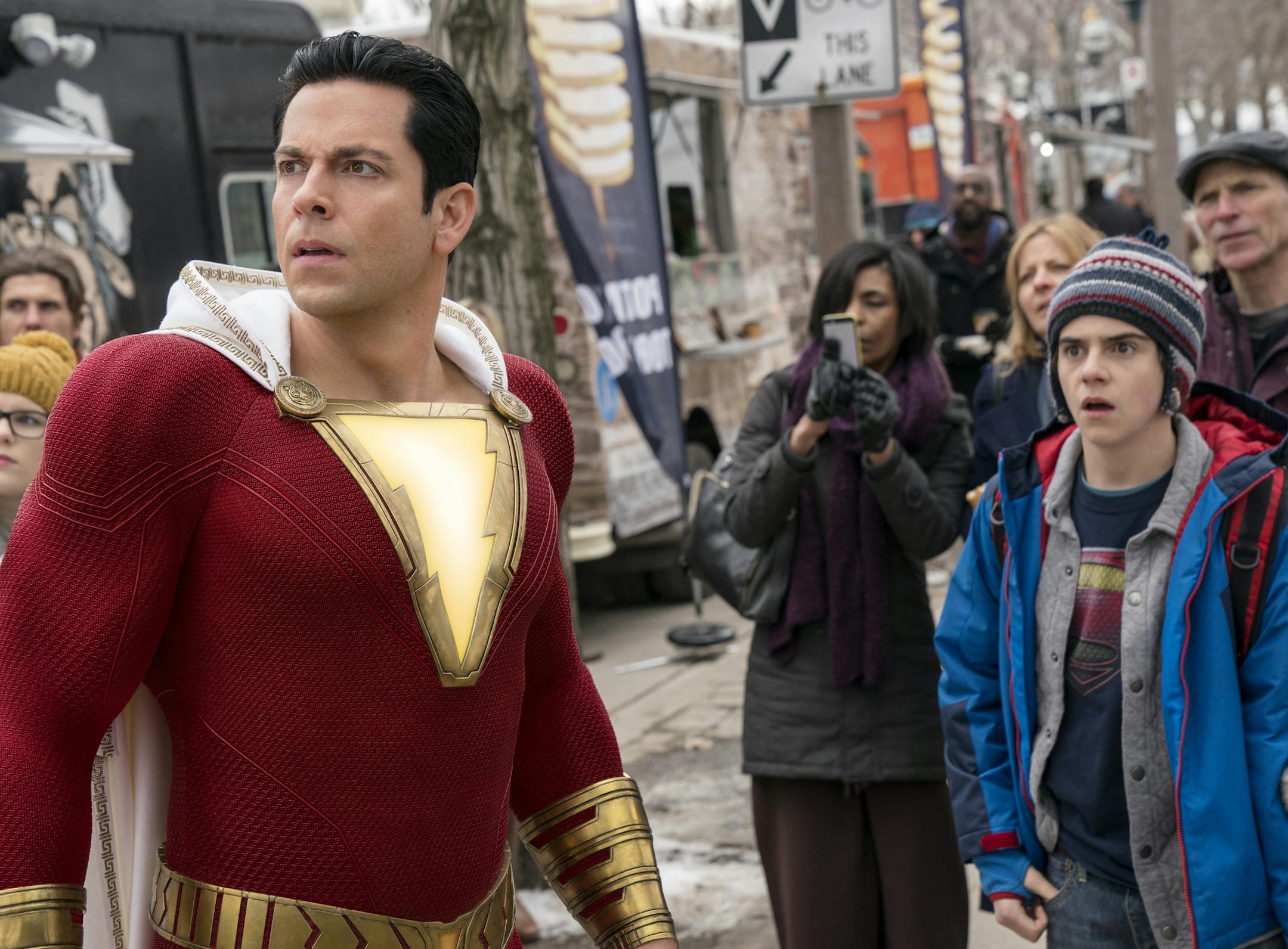 This image released by Warner Bros. shows Zachary Levi, left, and Jack Dylan Grazer in a scene from "Shazam!" (Steve Wilkie/Warner Bros. Entertainment via AP)