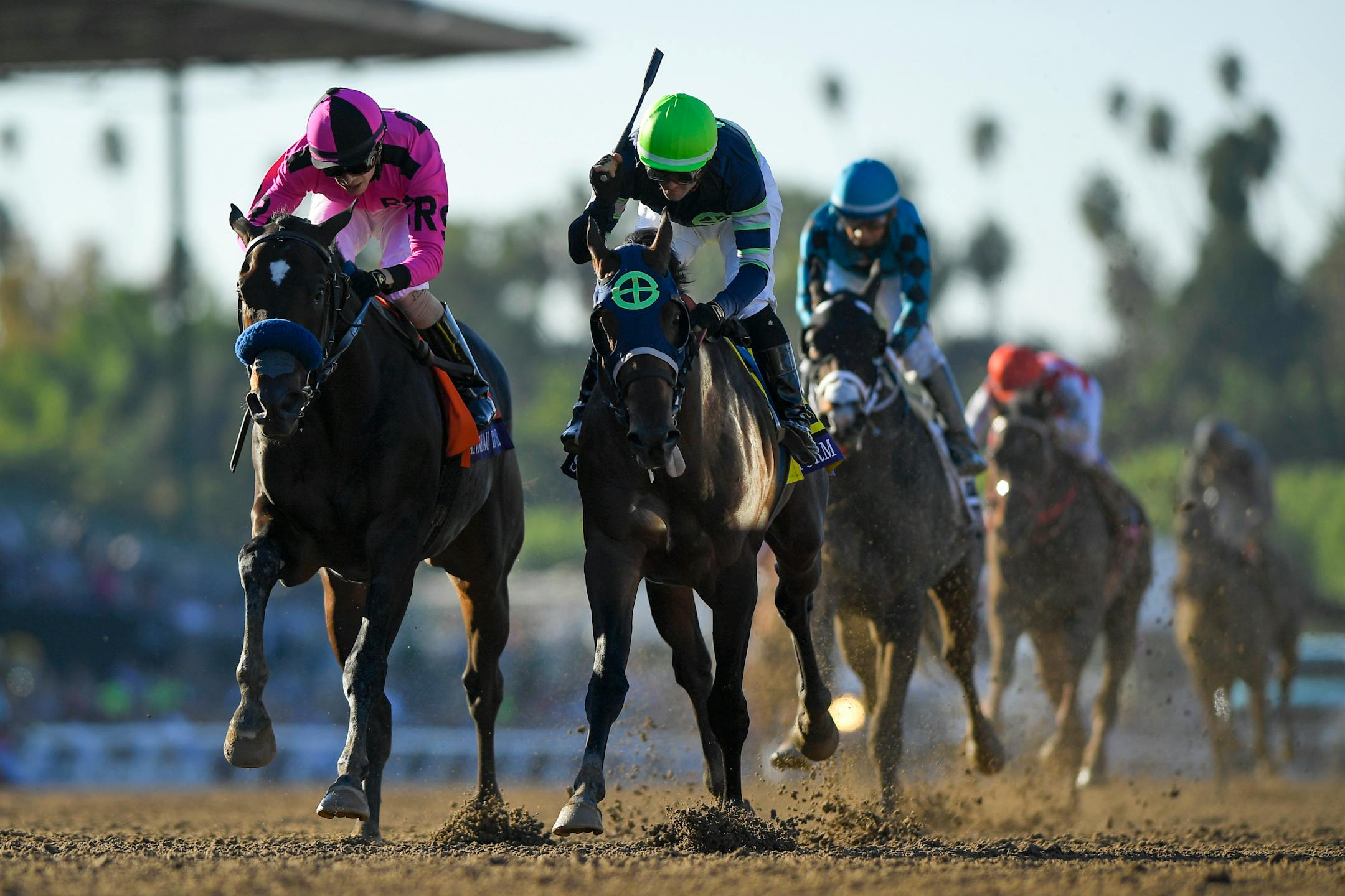 Flavien Prat, right, starts to celebrate after Storm the Court edged out Anneau D'or, left, for the win in the Breeders' Cup Juvenile horse race at Santa Anita on Friday