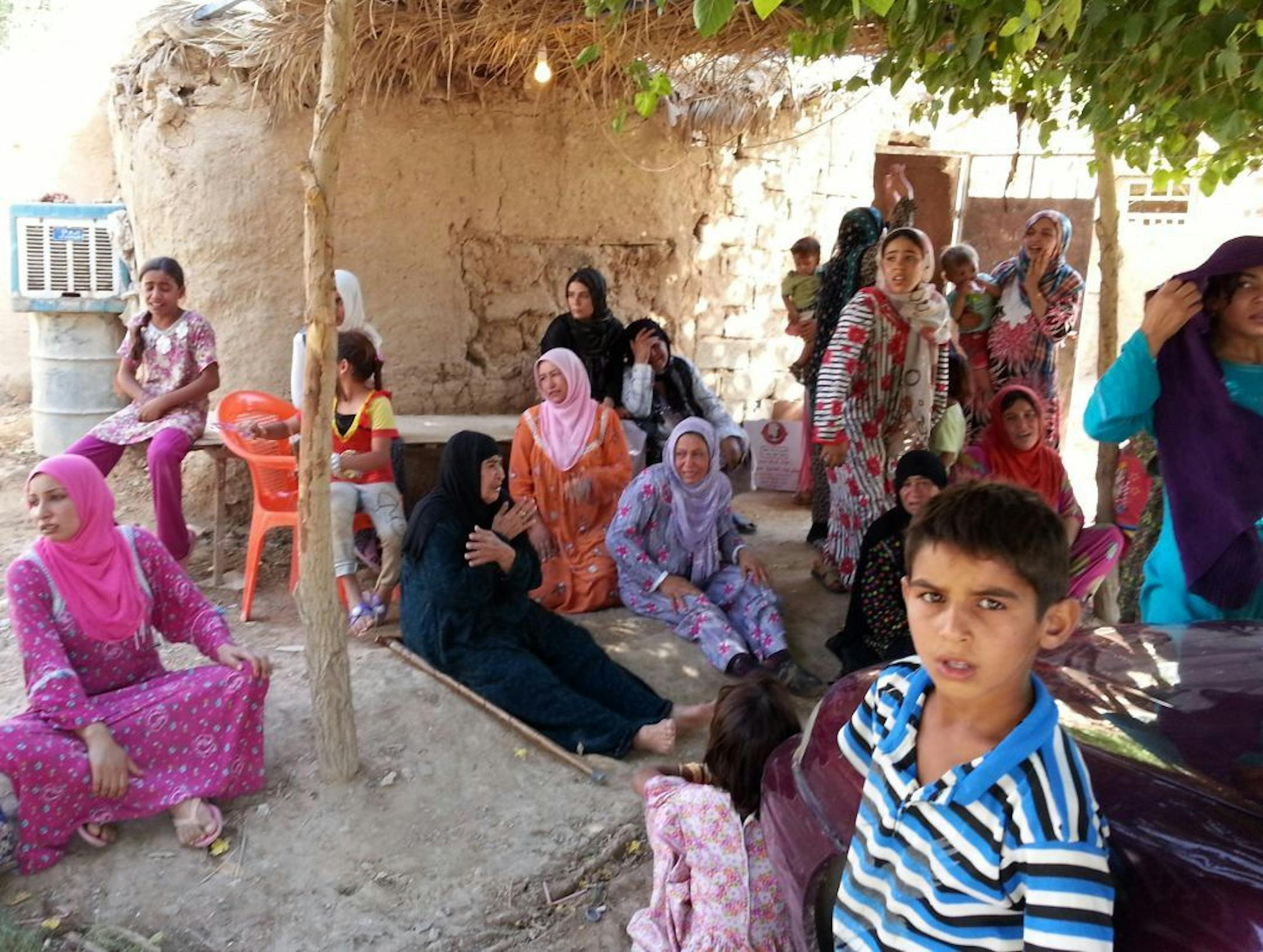 Iraqi women and children gather outside of a Sunni mosque after a suicide bomber struck during Friday prayers in the village of Umm al-Adham in Diyala province, a former militant stronghold 60 kilometers (35 miles) northeast of Baghdad, Iraq, Friday, Sept. 13, 2013. Iraq is weathering it deadliest bout of violence in half a decade, raising fears the country is returning to the widespread killing that pushed it to the brink of civil war following the 2003 U.S.-led invasion.