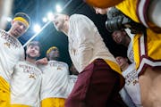 Gophers senior Parker Fox, middle, hypes up the team before Thursday's loss to Michigan State in the second round of the Big Ten tournament at Target 