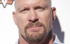 WWE Hall of Famer Stone Cold Steve Austin attends the SummerSlam Confidential Panel at Club Nokia, on Saturday, August 16, 2014 in Los Angeles. (Photo