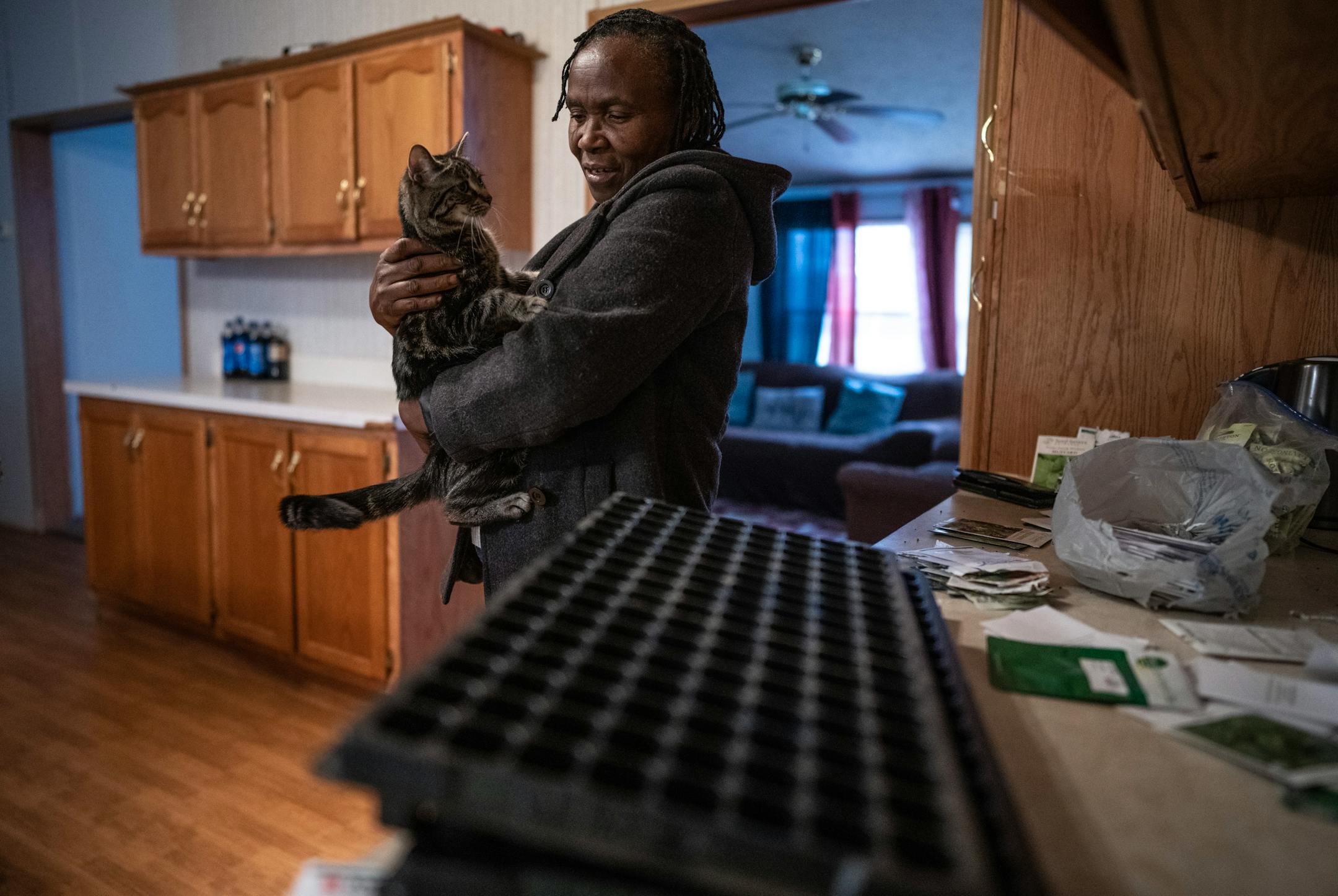 Jane Windsperger, with her cat, Nala, inside her home.
