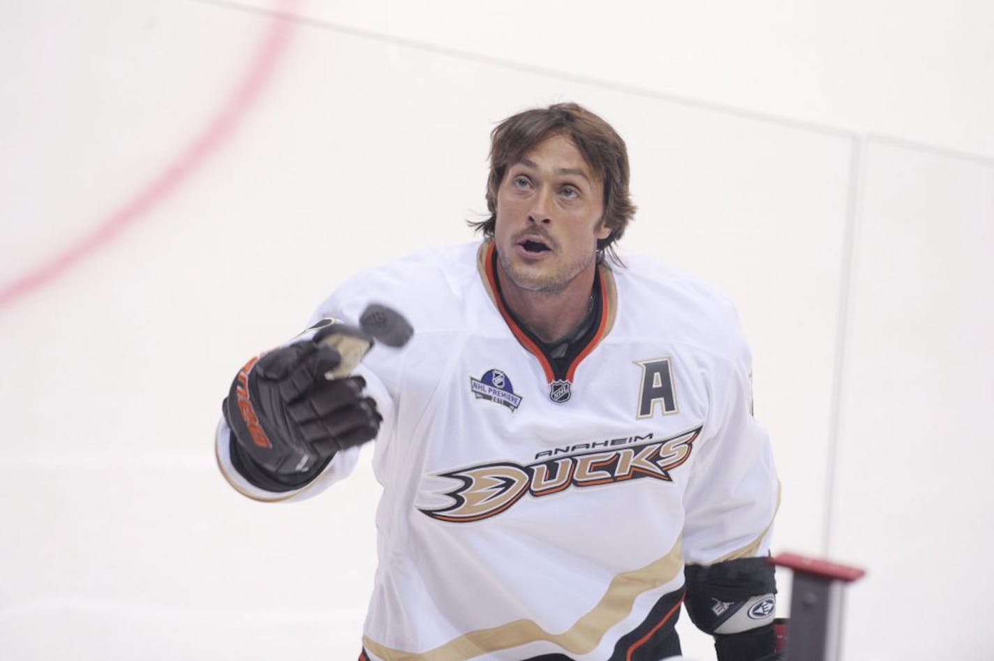 Anaheim Ducks forward Teemu Sel�nne throws pucks to spectators as he warms up ahead of the ice hockey NHL season opener game Buffalo Sabres vs Anaheim Ducks in Helsinki, Finland, on Friday Oct. 7, 2011. (AP Photo / LEHTIKUVA / Martti Kainulainen) FINLAND OUT NO SALES