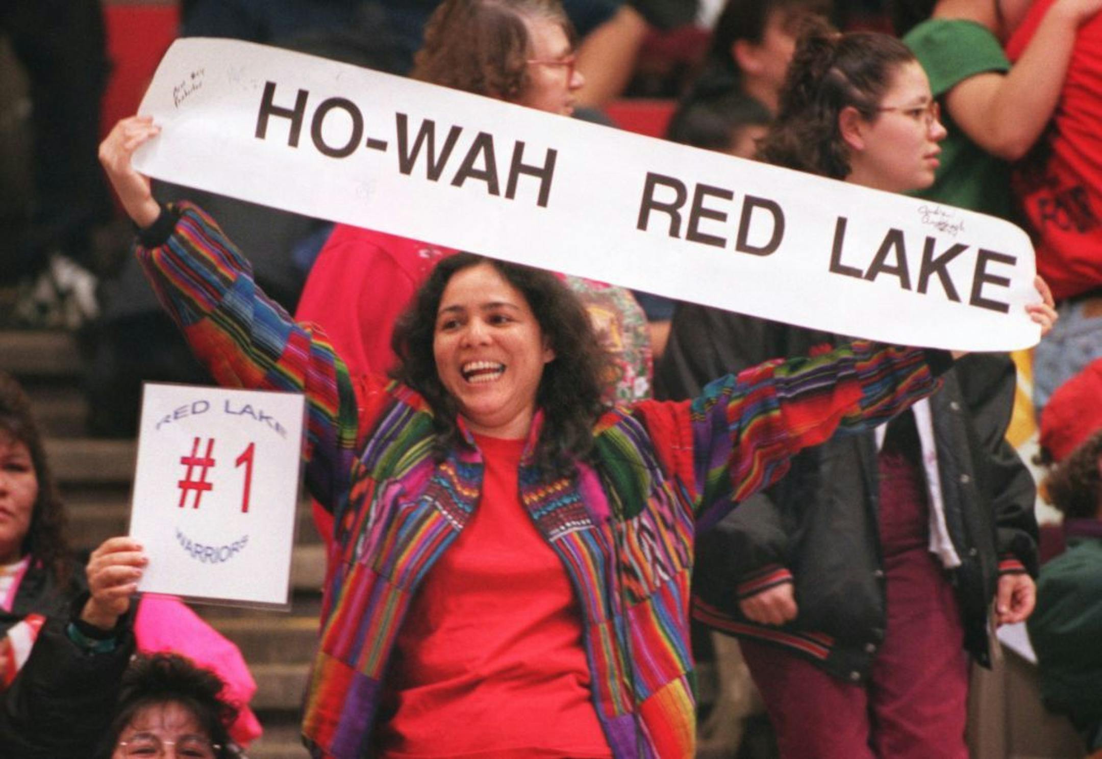 see Doug Grow in Friday's paper -- Andria Lawrence of Minneapolis holds up a banner in support of her team from Red Lake. Ho-Wah roughly translates into �way to go� . Red lake is the first time a reservation team has gone to the state championships.