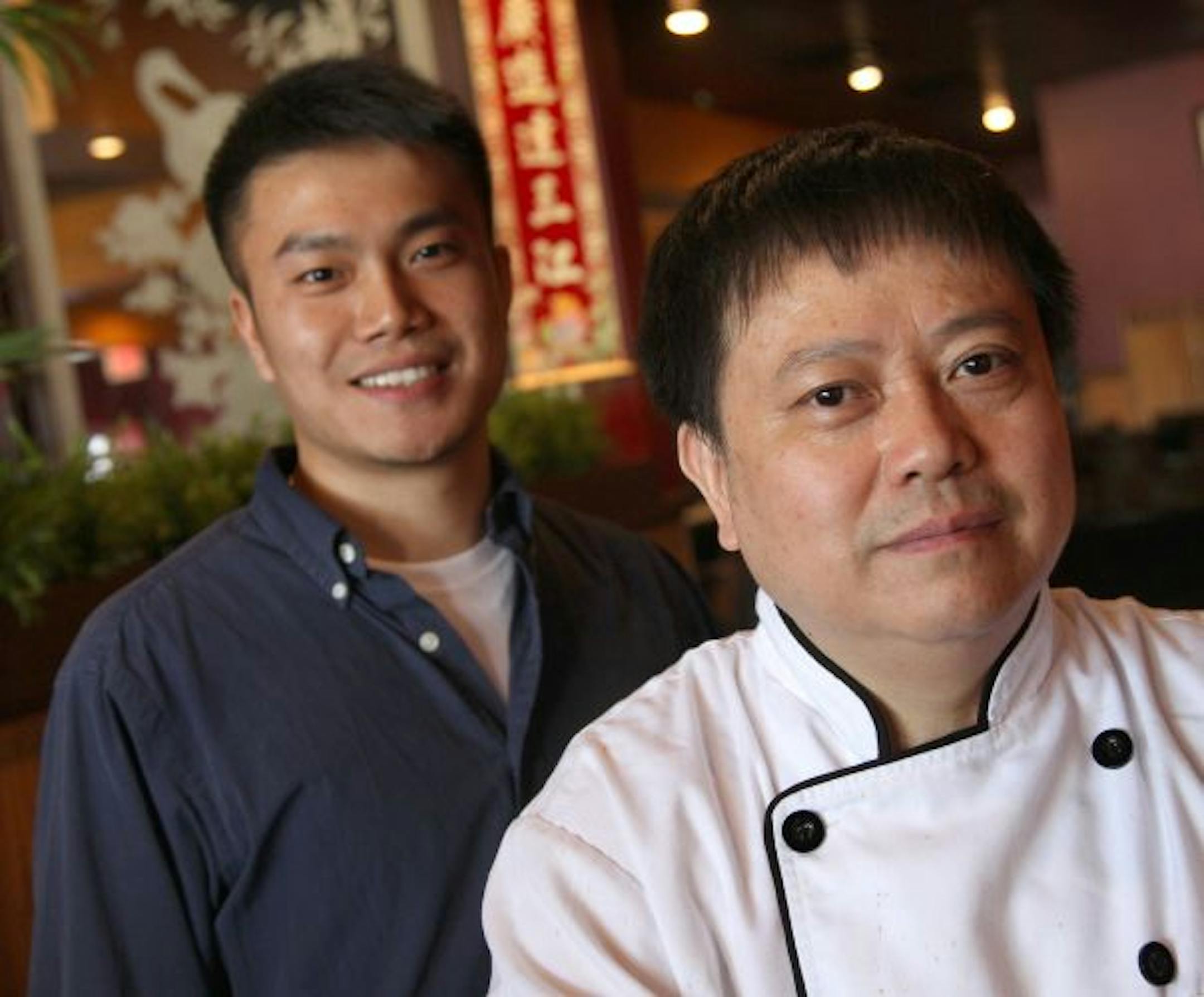Grand Szechuan owner Dan Luo, left, counts on his chef dad, Guanghe Luo, to prepare the extensive food offerings in his restaurant.