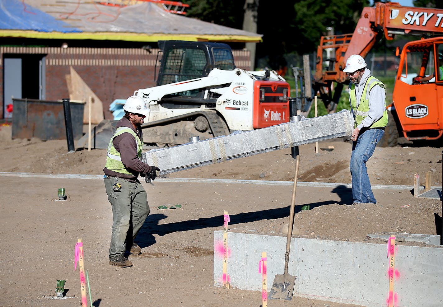 Construction crew worked on a filtration system and swimming pool early Wednesday, July 16, 2014 in Minneapolis.